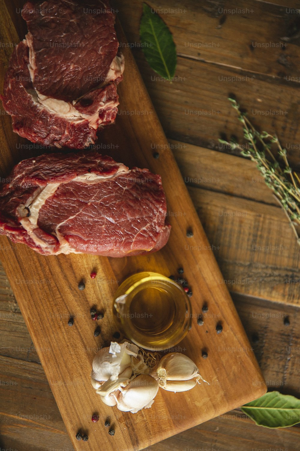 a wooden cutting board topped with raw meat