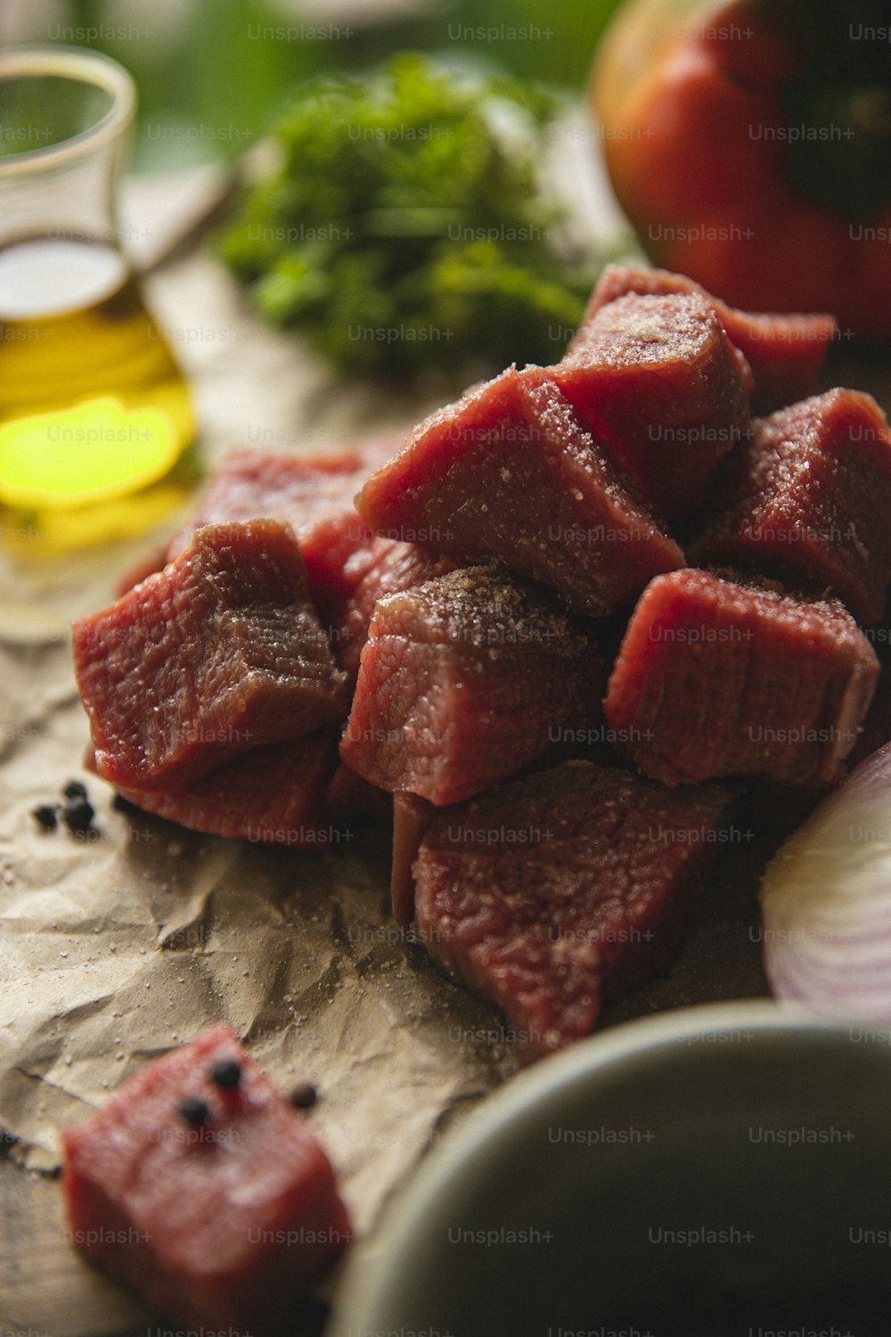 a pile of raw meat sitting on top of a wooden cutting board