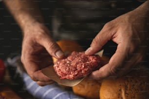 a close up of a person holding a hamburger