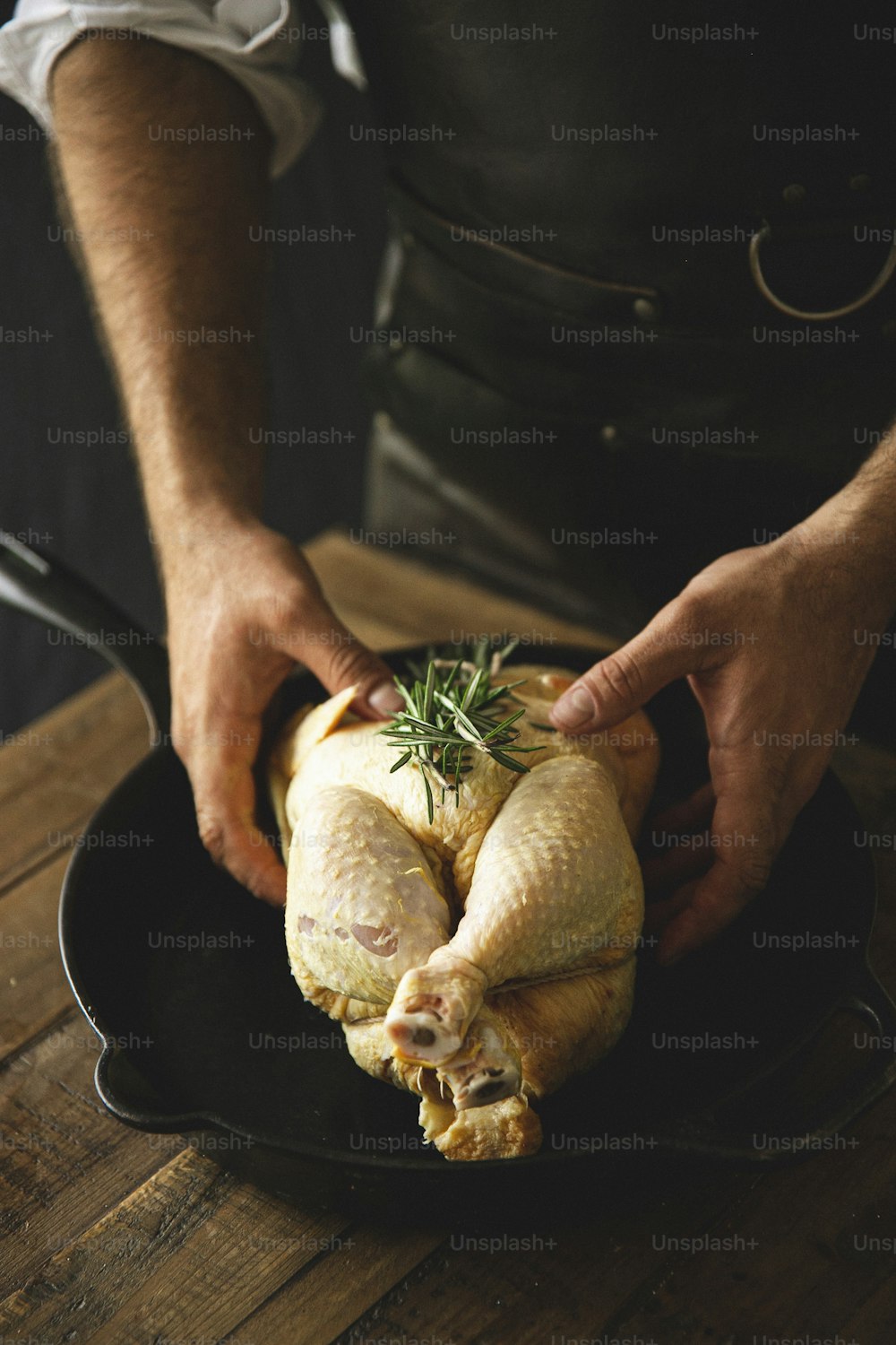 a person holding a turkey in a pan