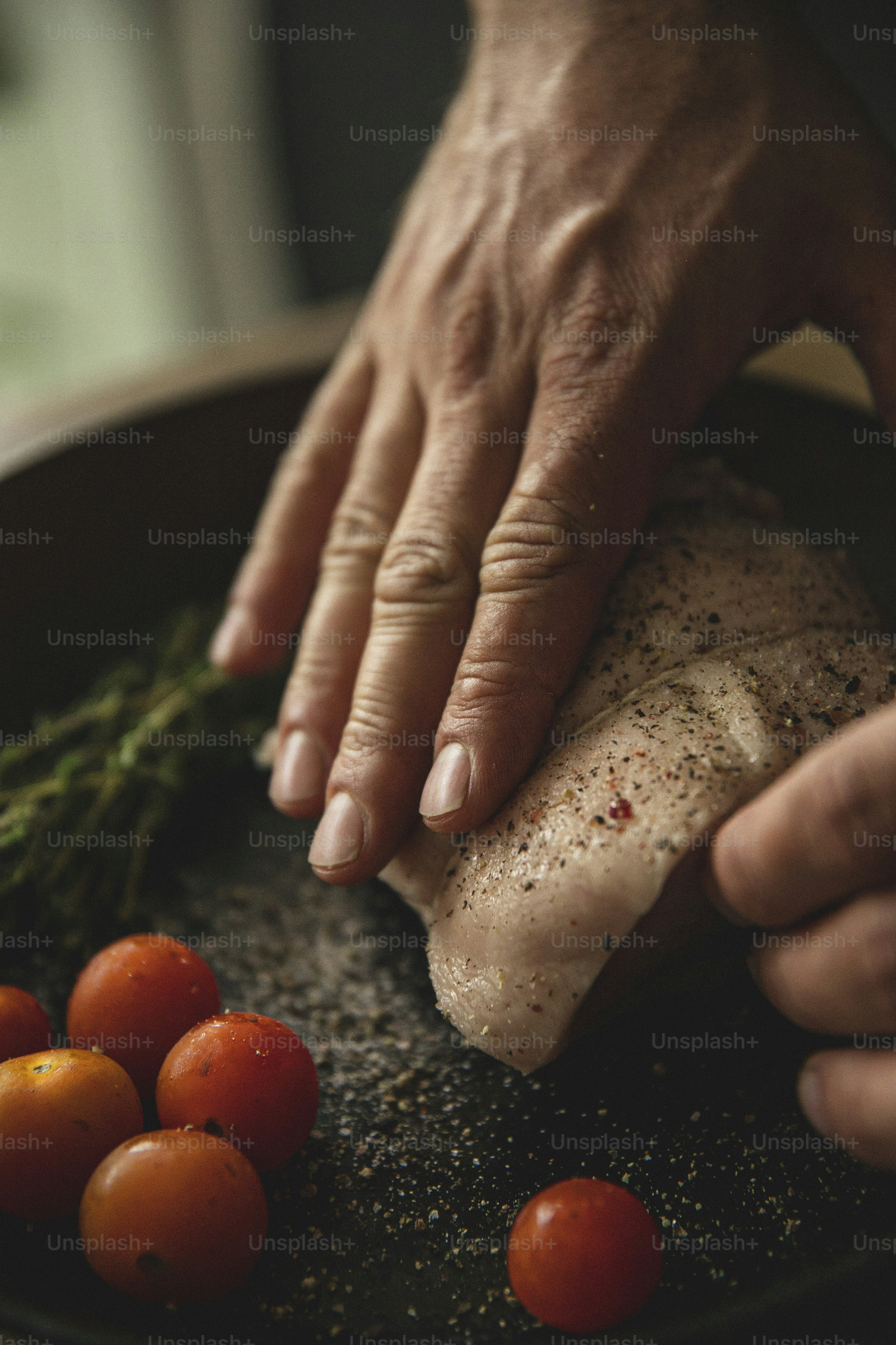 a close up of a person holding a piece of meat