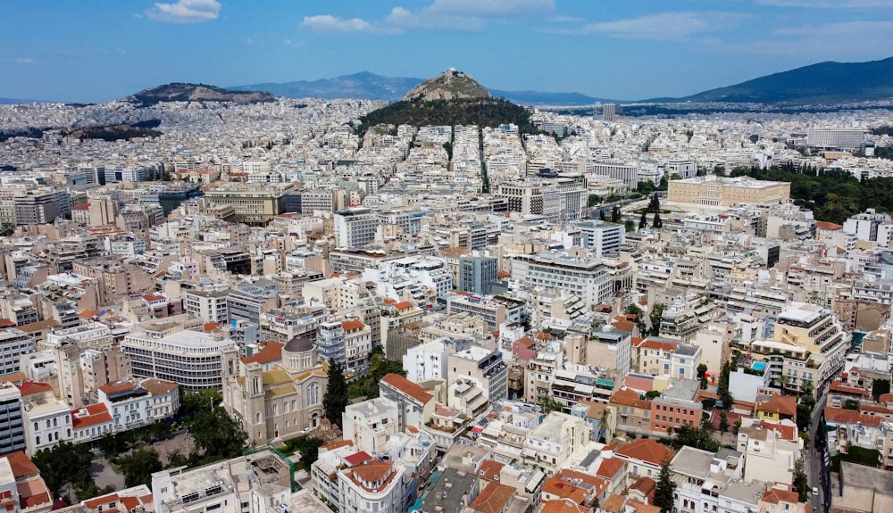 an aerial view of a city with a mountain in the background