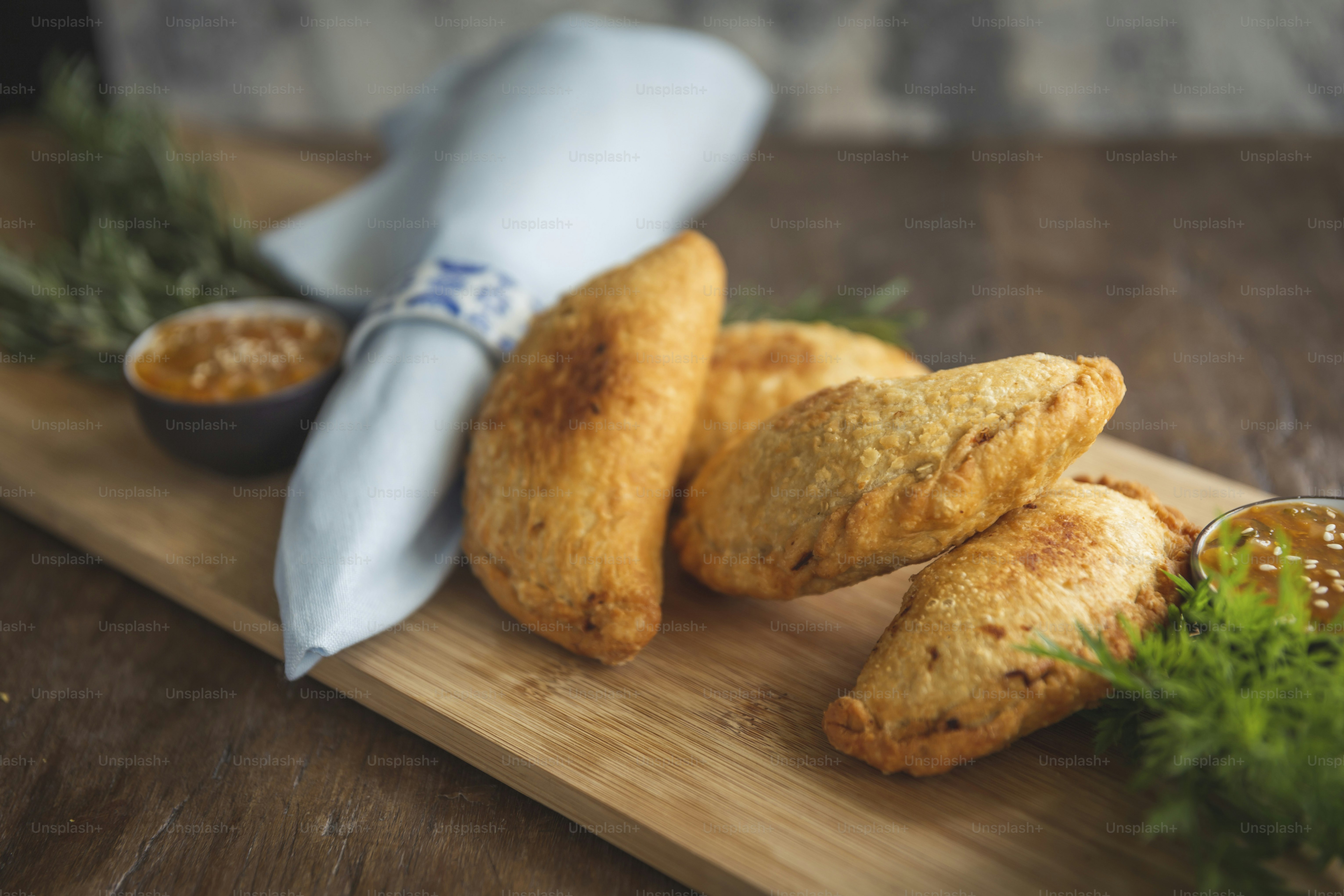 a wooden cutting board topped with fried food