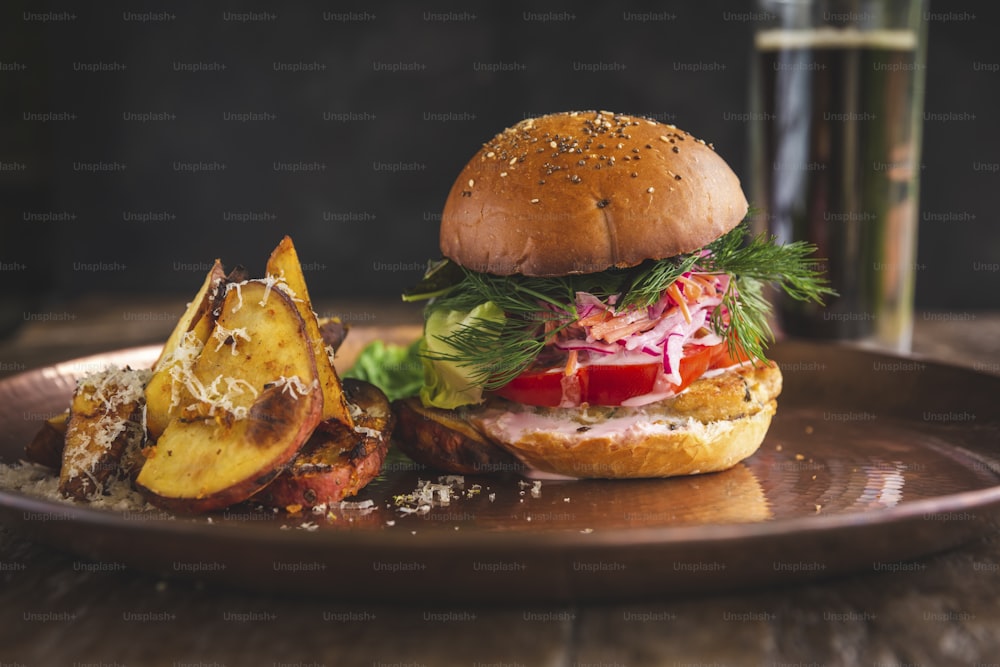 a plate with a sandwich and potatoes on it