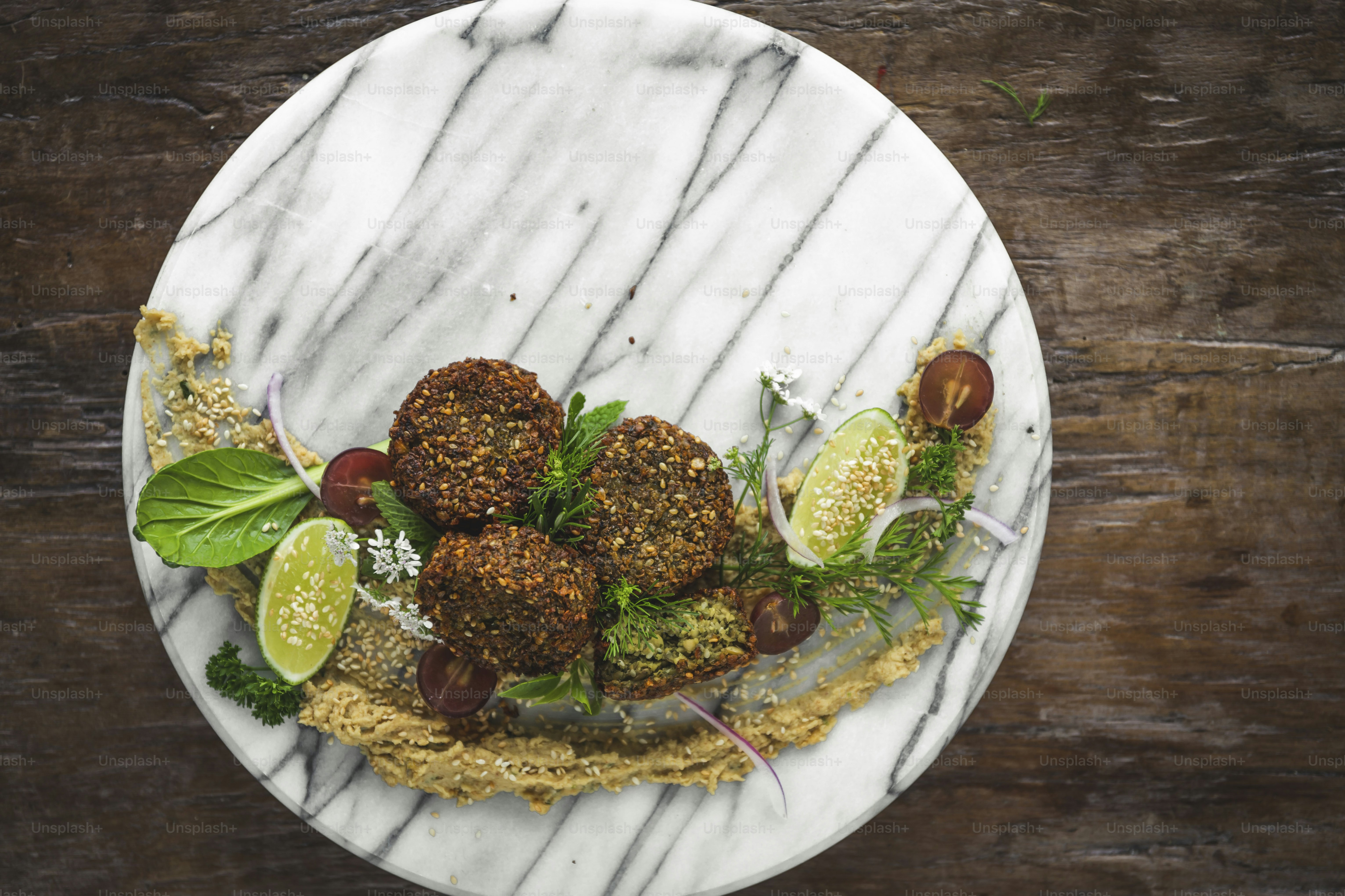 a white plate topped with meatballs covered in toppings