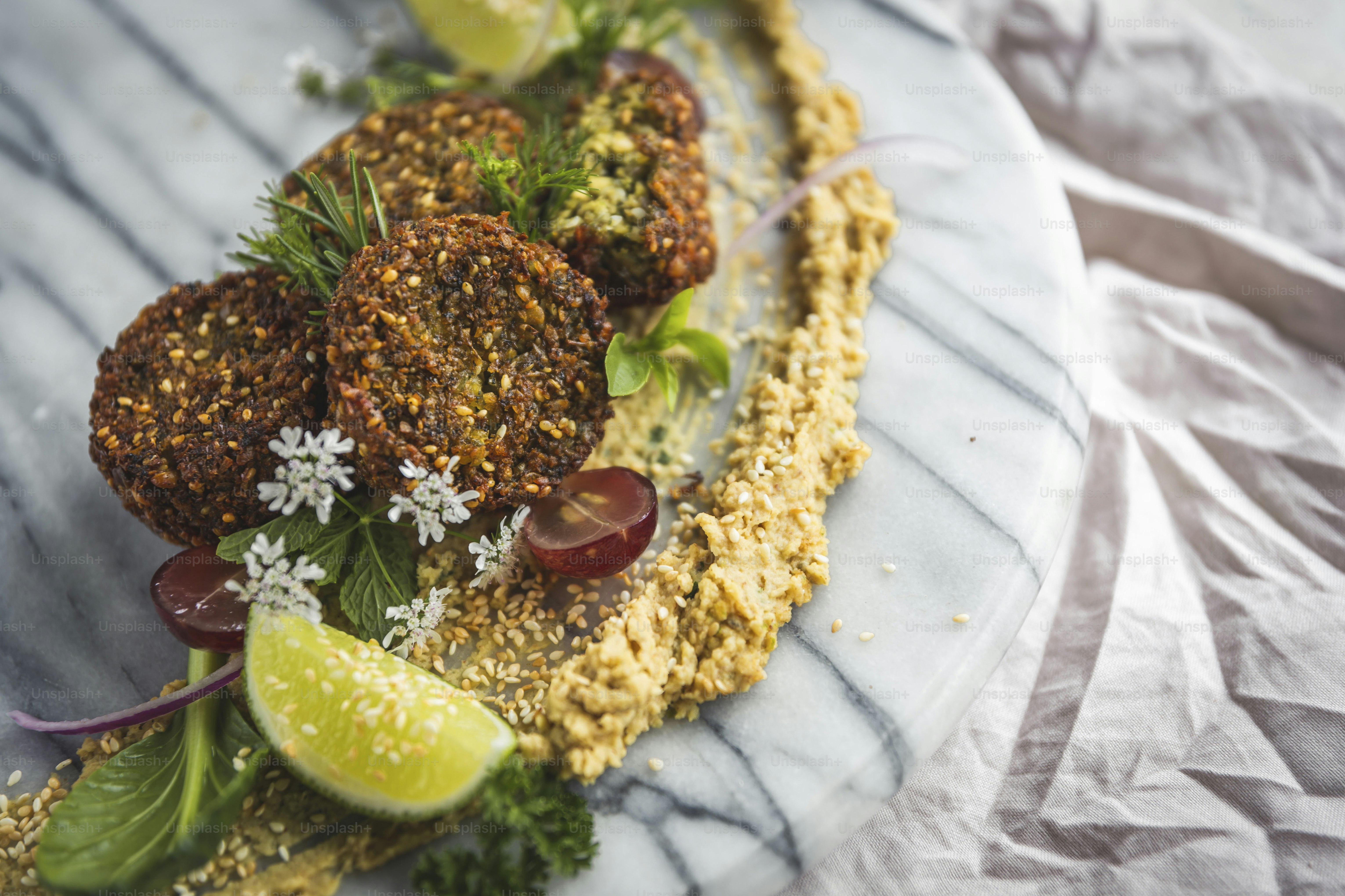 a white plate topped with meatballs covered in toppings
