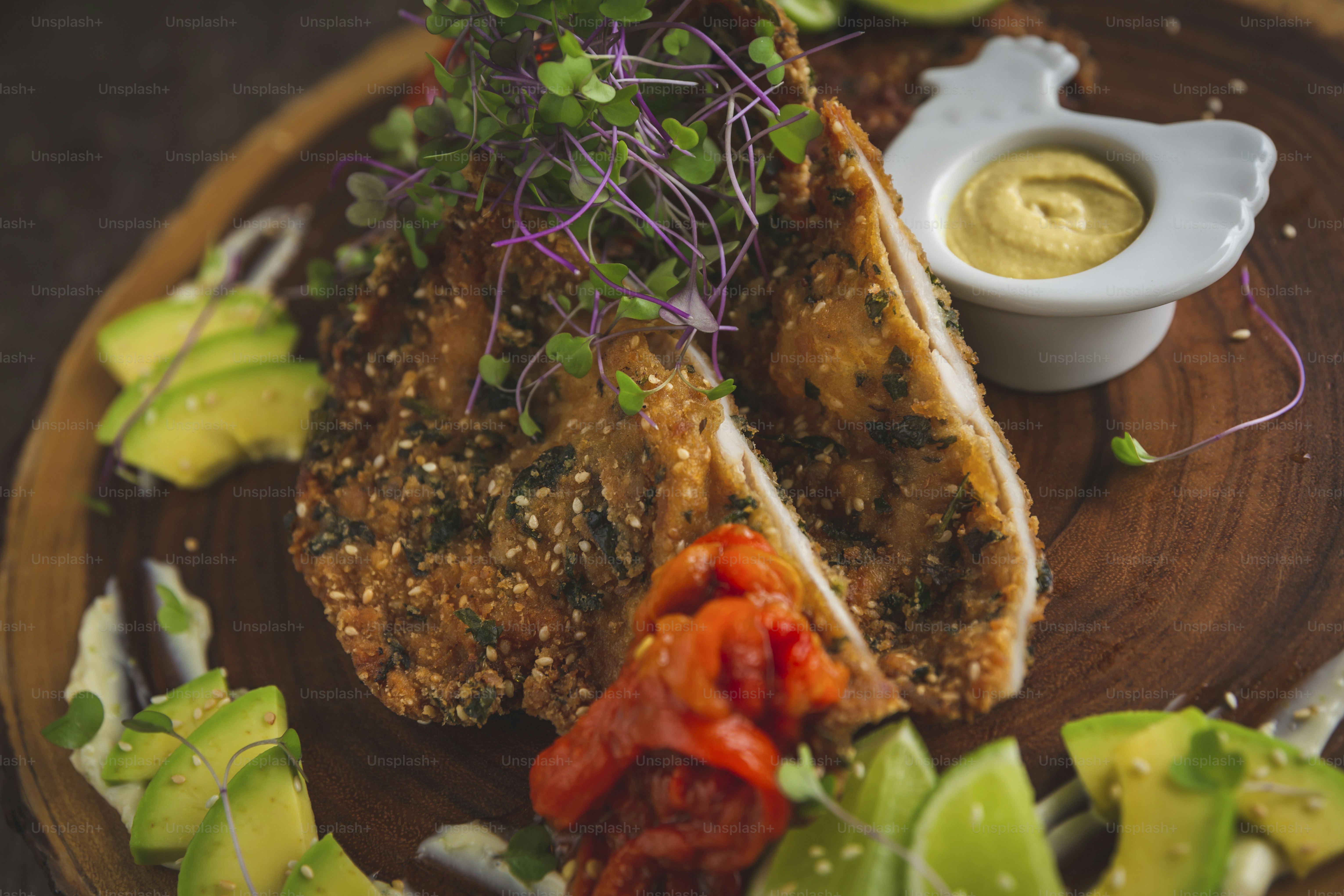 a wooden plate topped with meat and vegetables