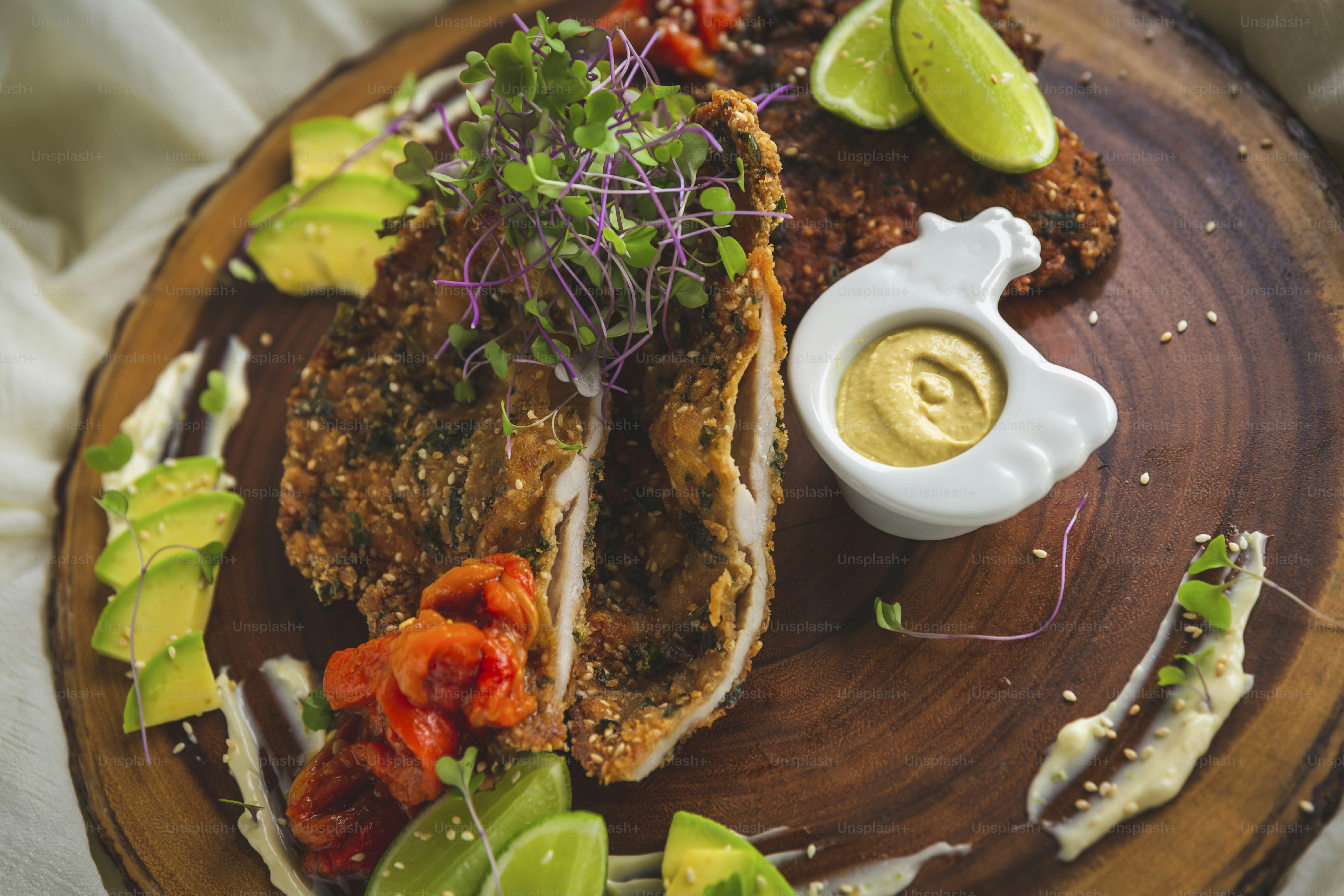a wooden plate topped with meat and vegetables