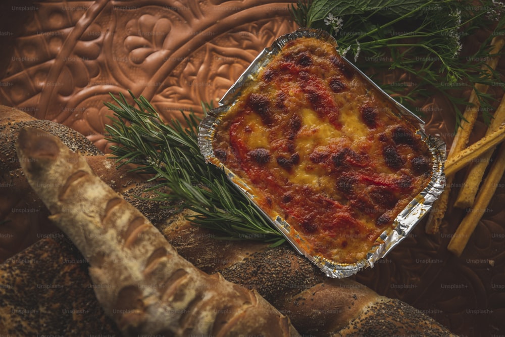 a casserole in a baking dish with a sprig of rosemary