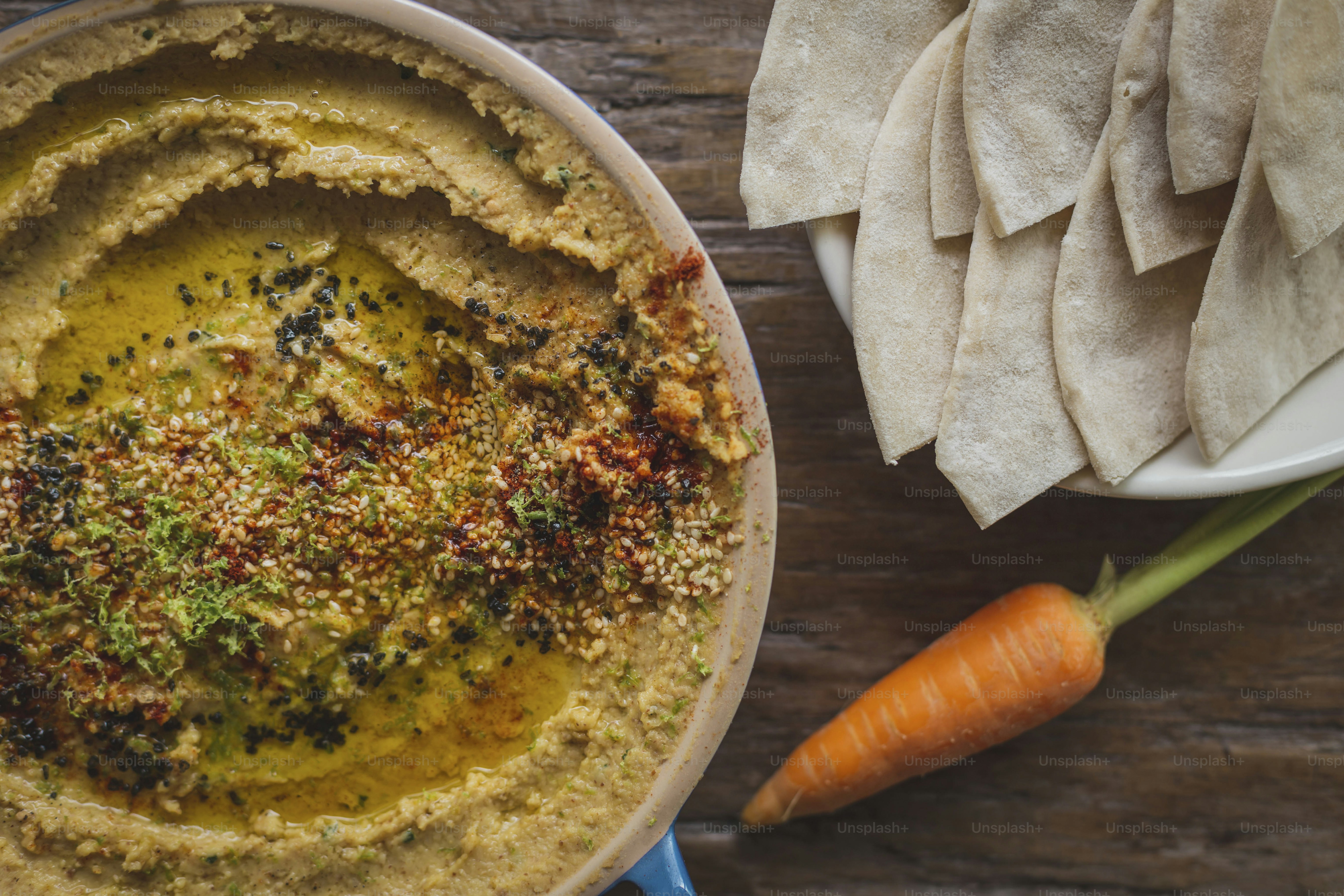 a bowl of hummus and a plate of tortilla chips