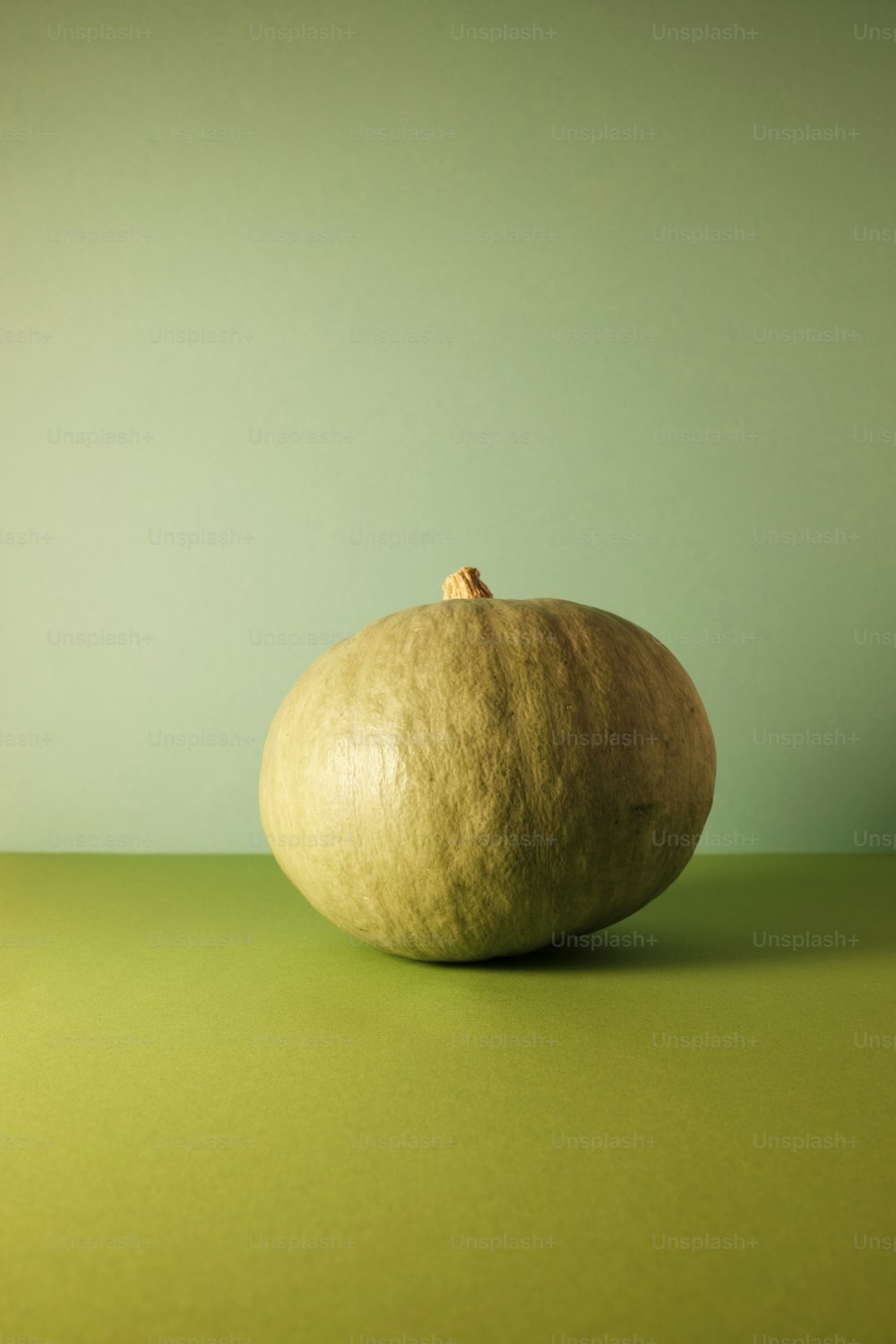 a piece of fruit sitting on top of a green table