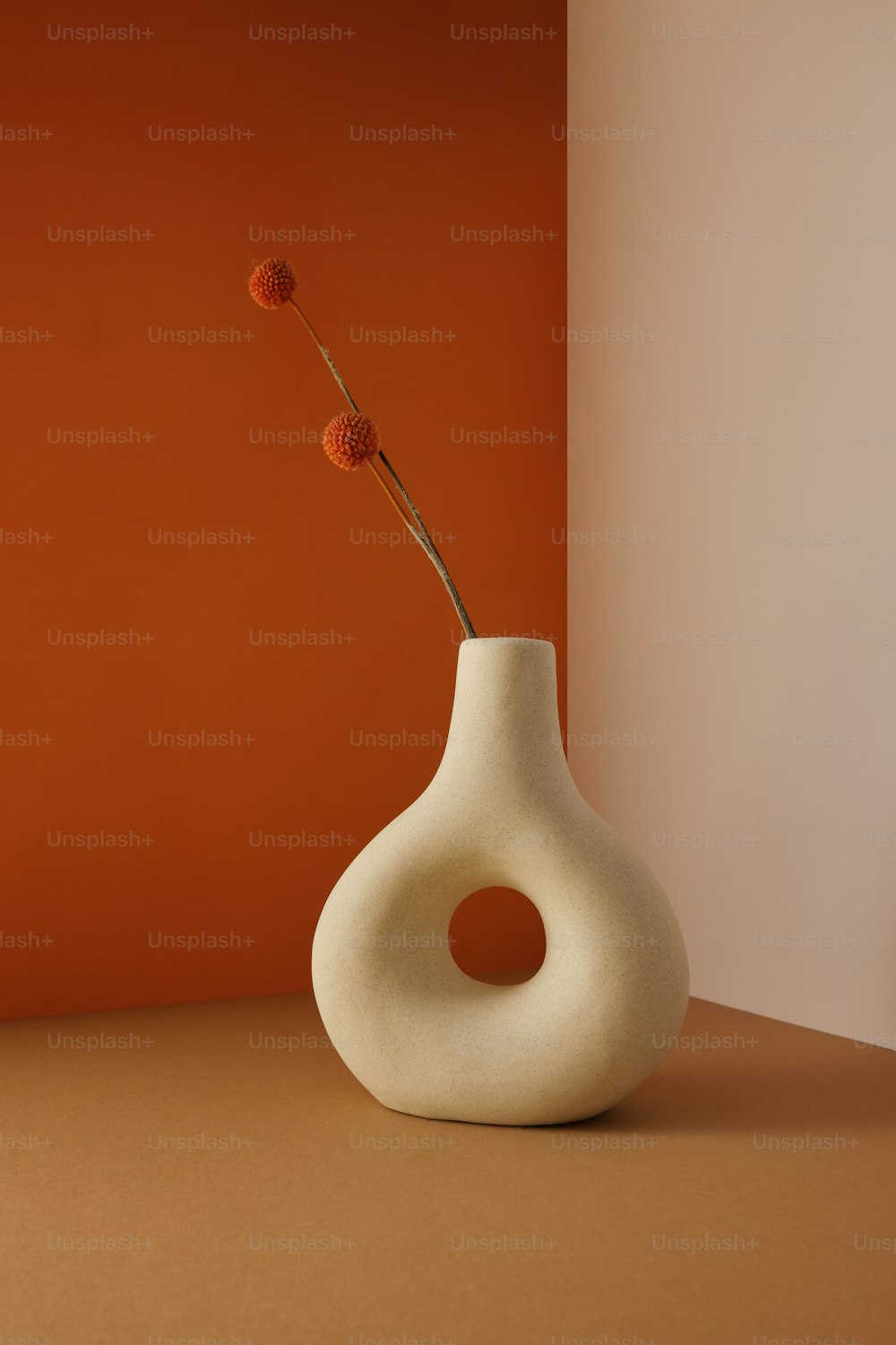 a white vase with a single flower in it
