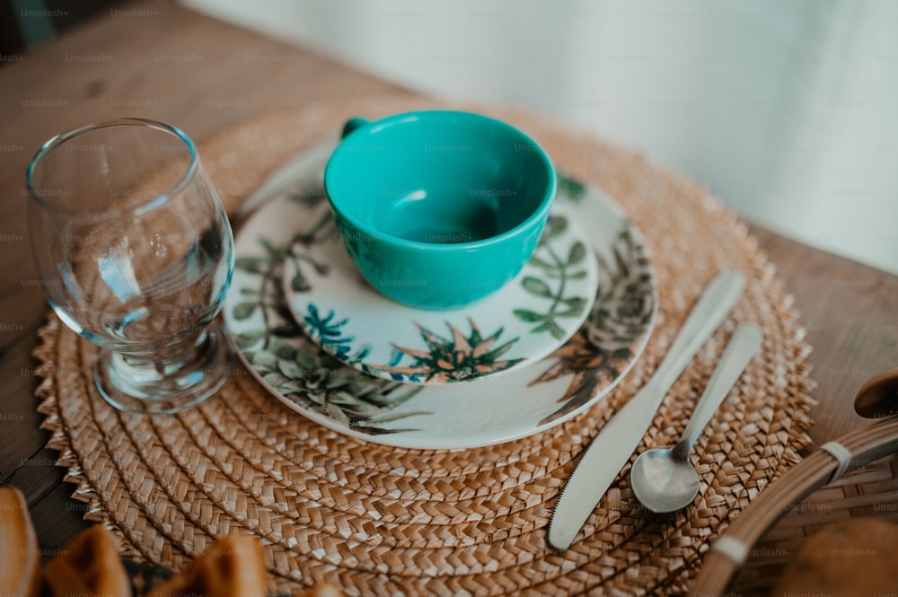 a place setting with a bowl and a glass