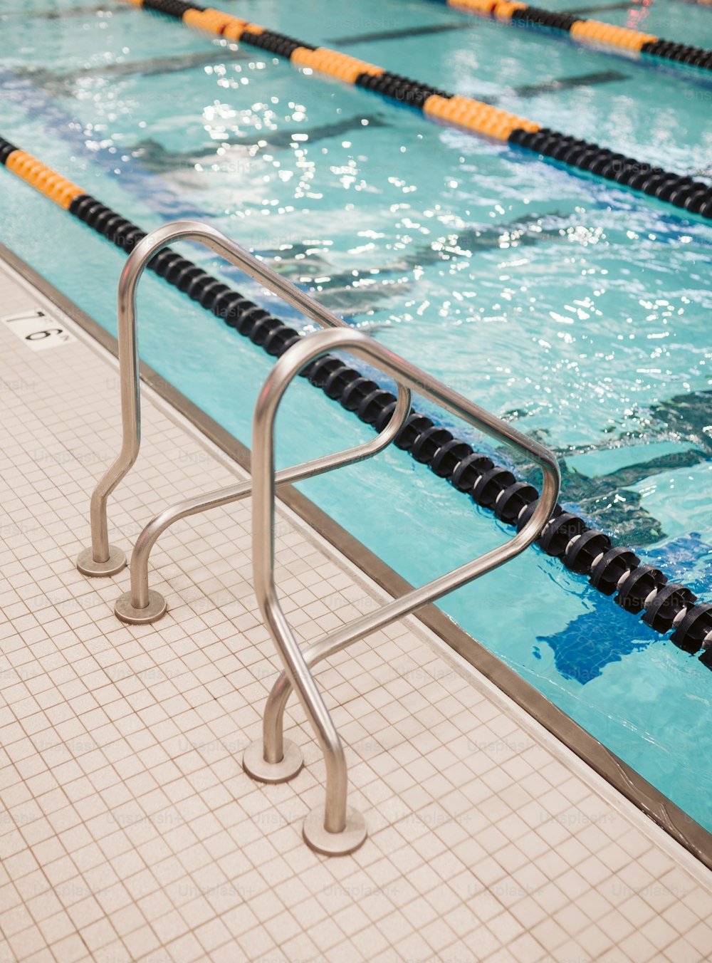 a swimming pool with a metal hand rail