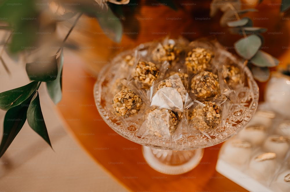 a table topped with a cake and a vase filled with flowers