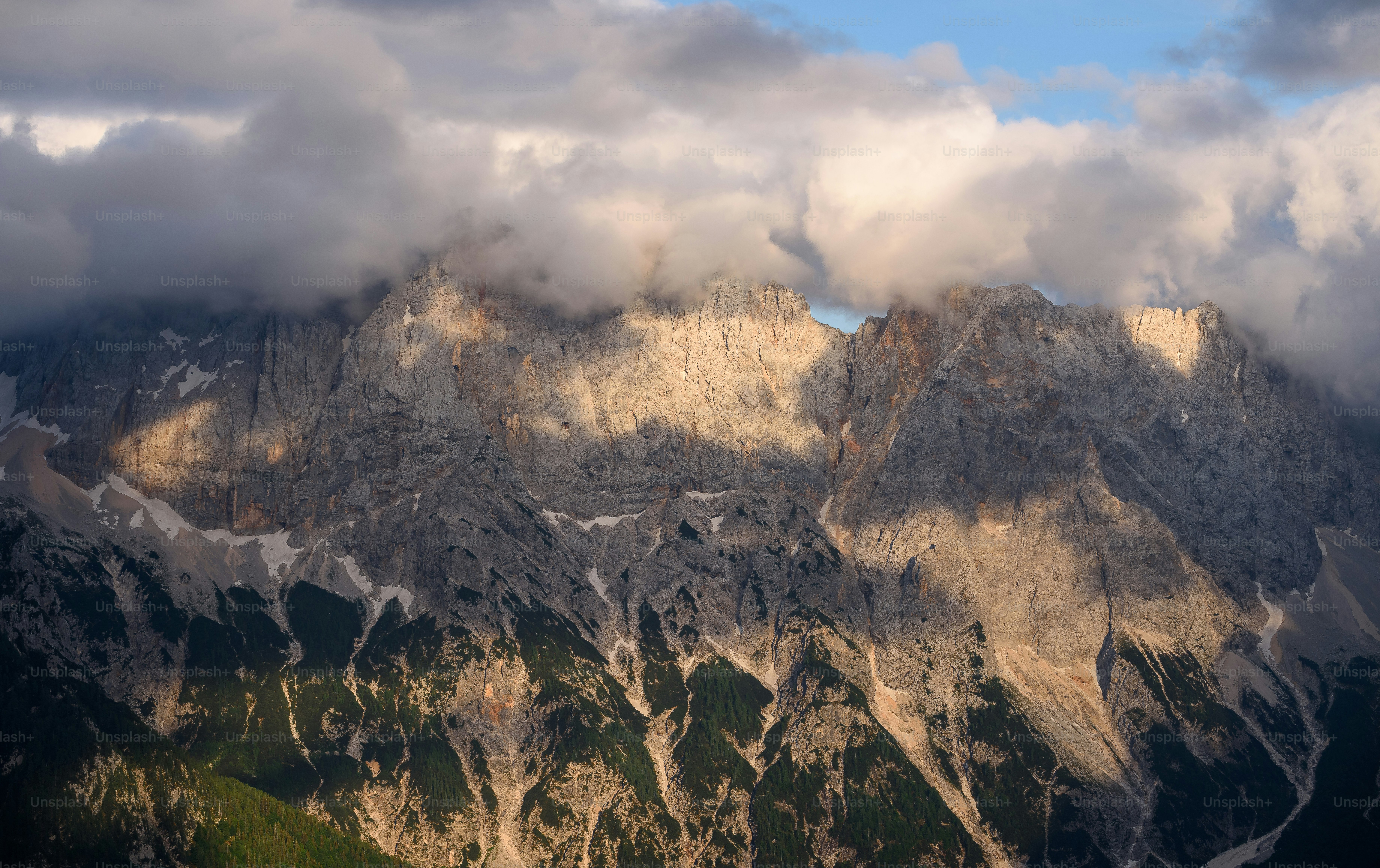 a view of a mountain range with clouds in the sky