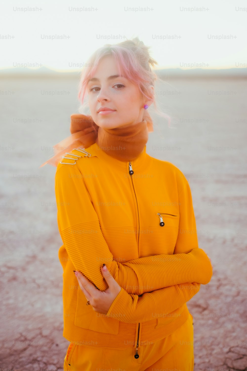 a woman with pink hair wearing a yellow outfit