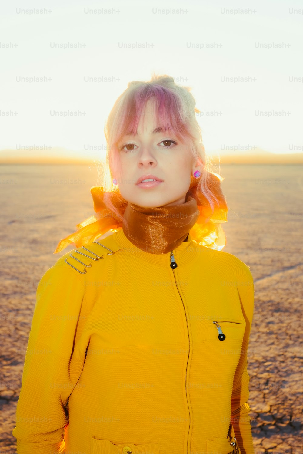 a woman with pink hair wearing a yellow jacket