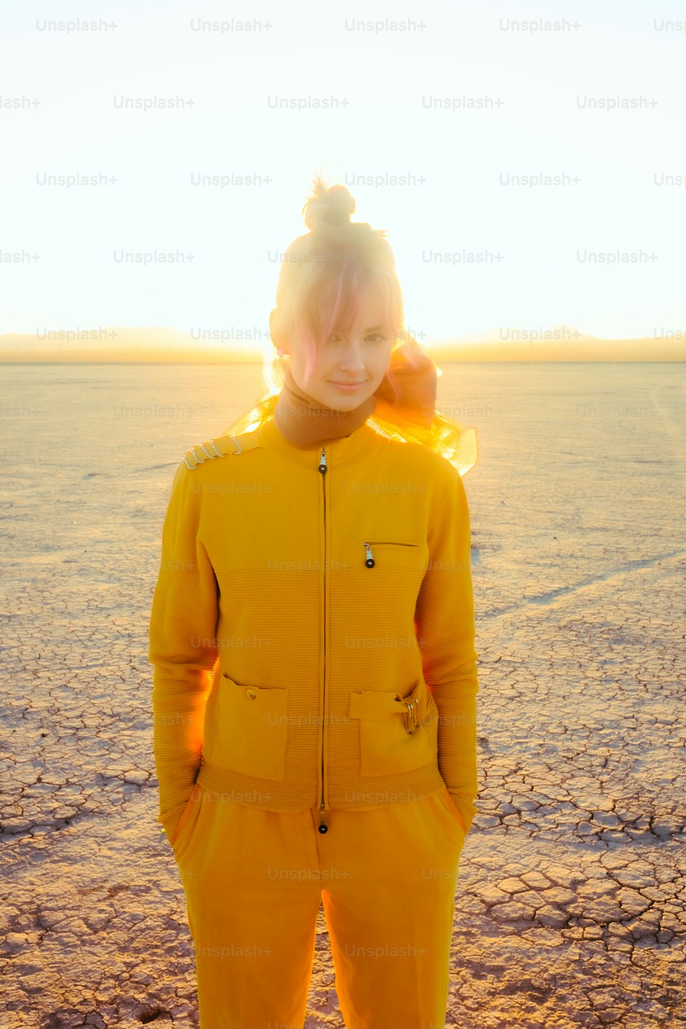 a person in a yellow suit standing on a beach