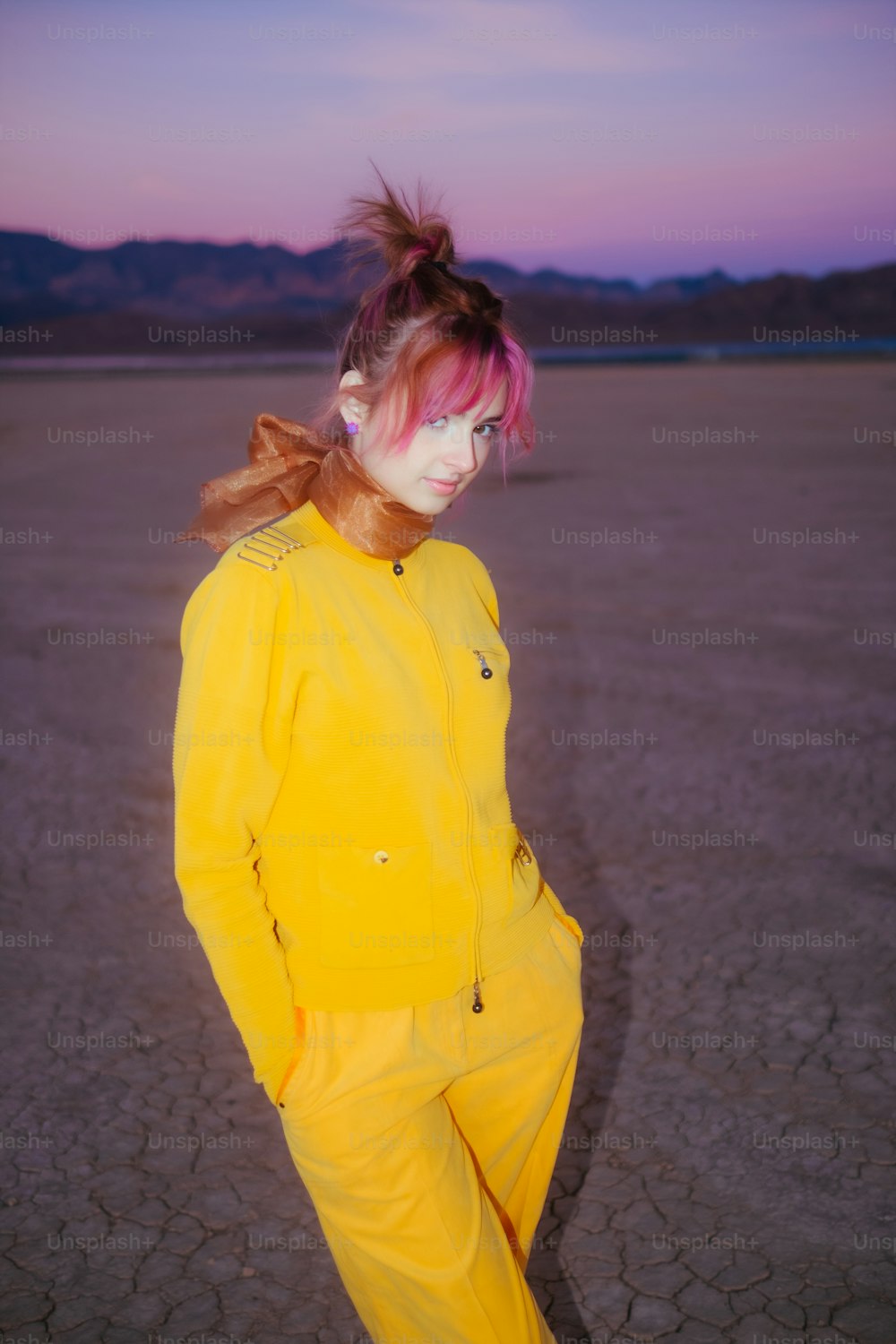 a woman with pink hair in a yellow outfit