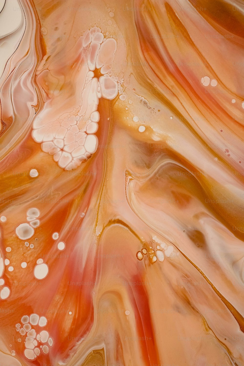 a close up of an orange and white liquid
