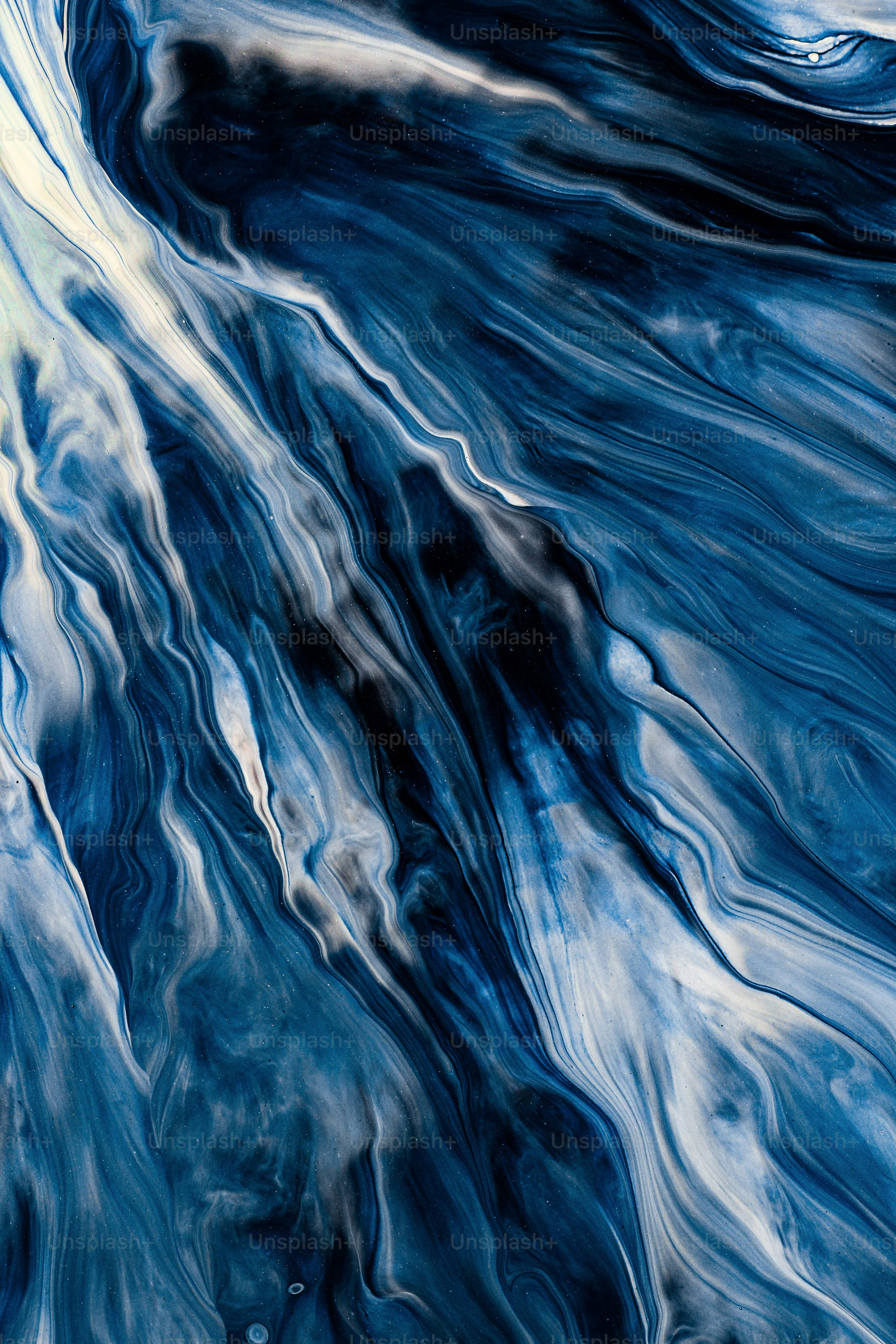 an abstract painting of blue and white waves