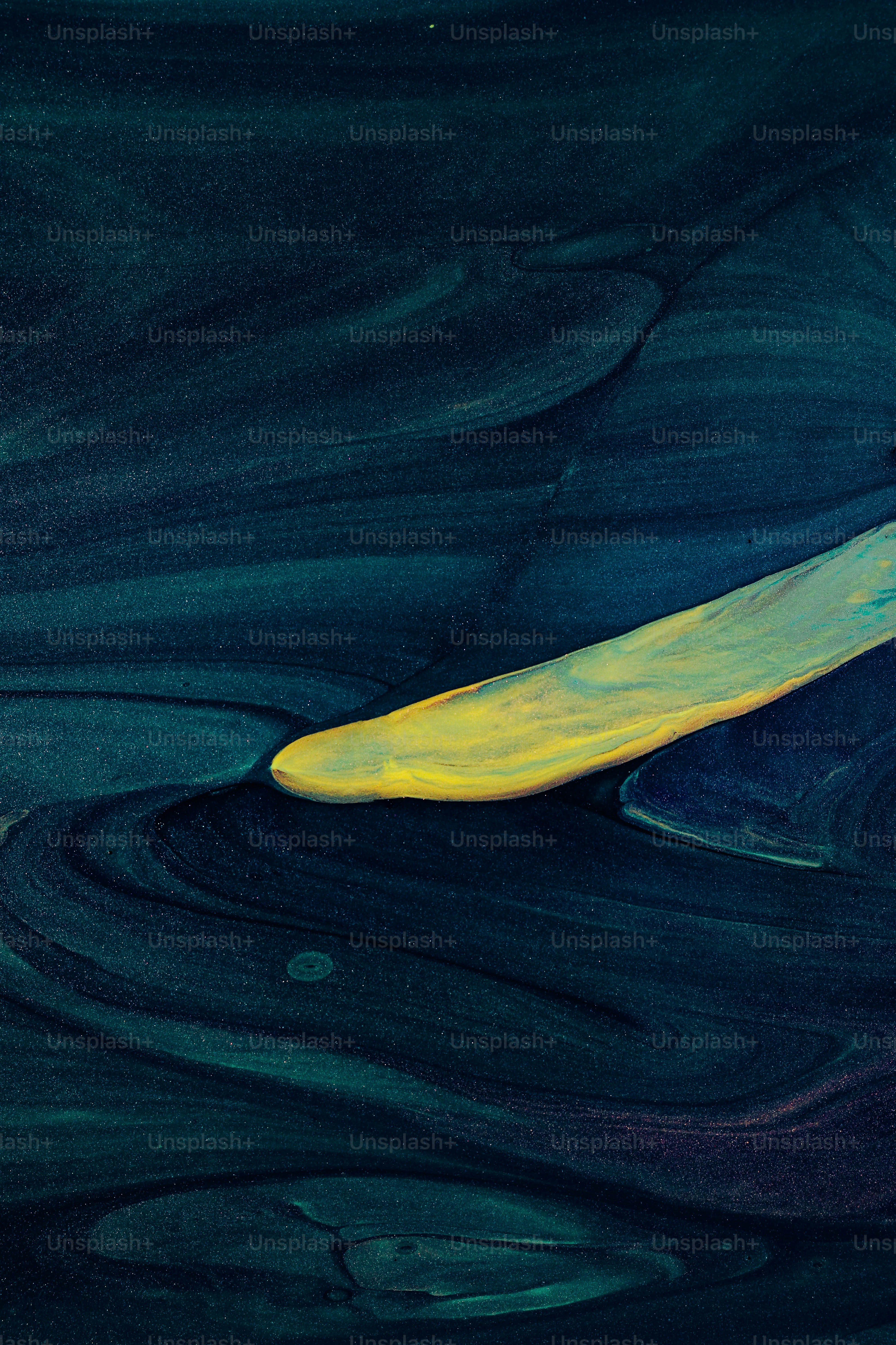 a yellow surfboard floating in the water