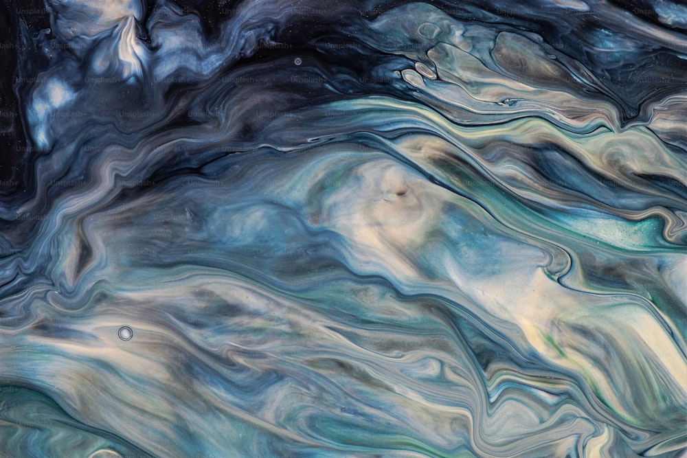 an abstract painting of blue, green, and white swirls