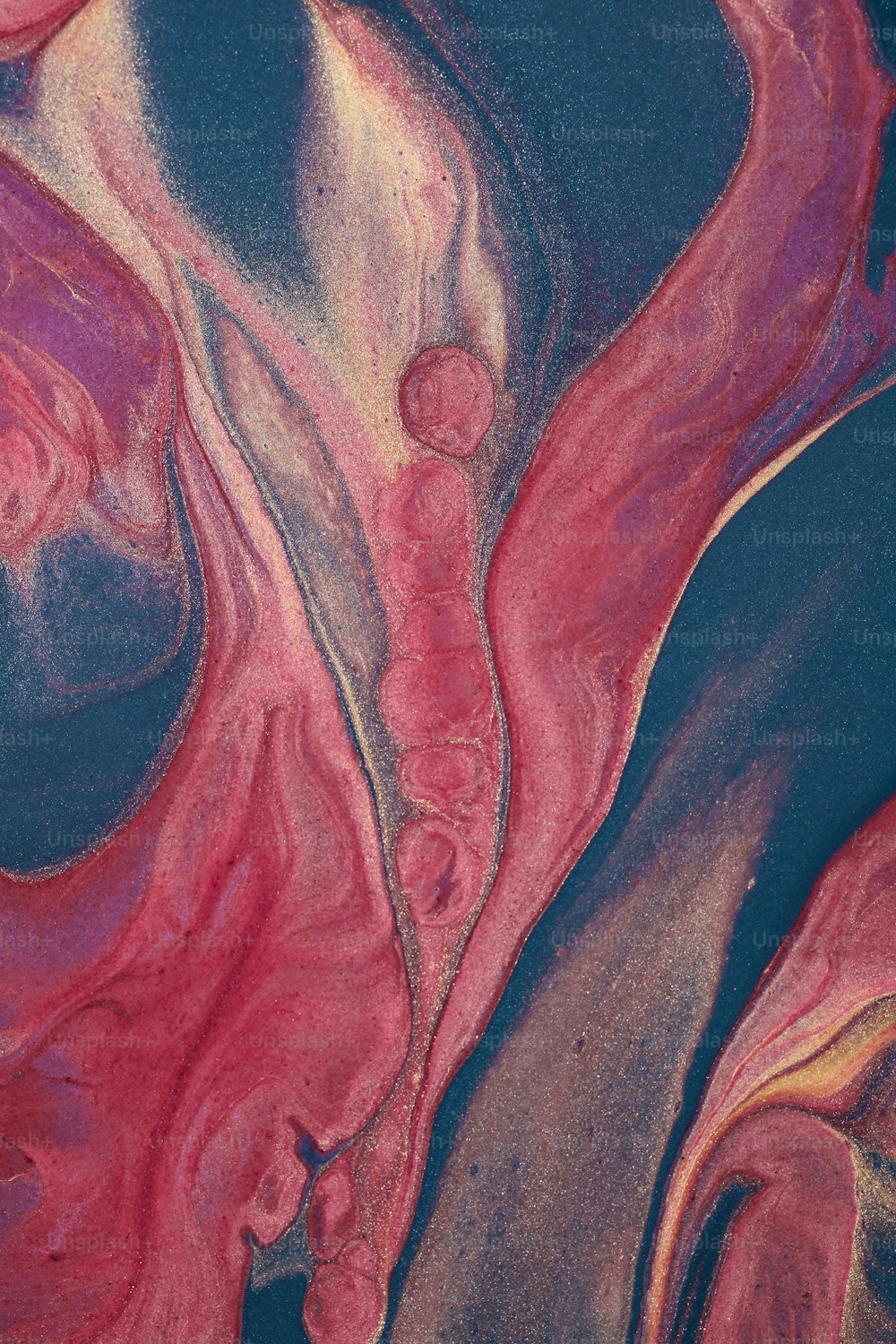 a close up of a pink and blue painting
