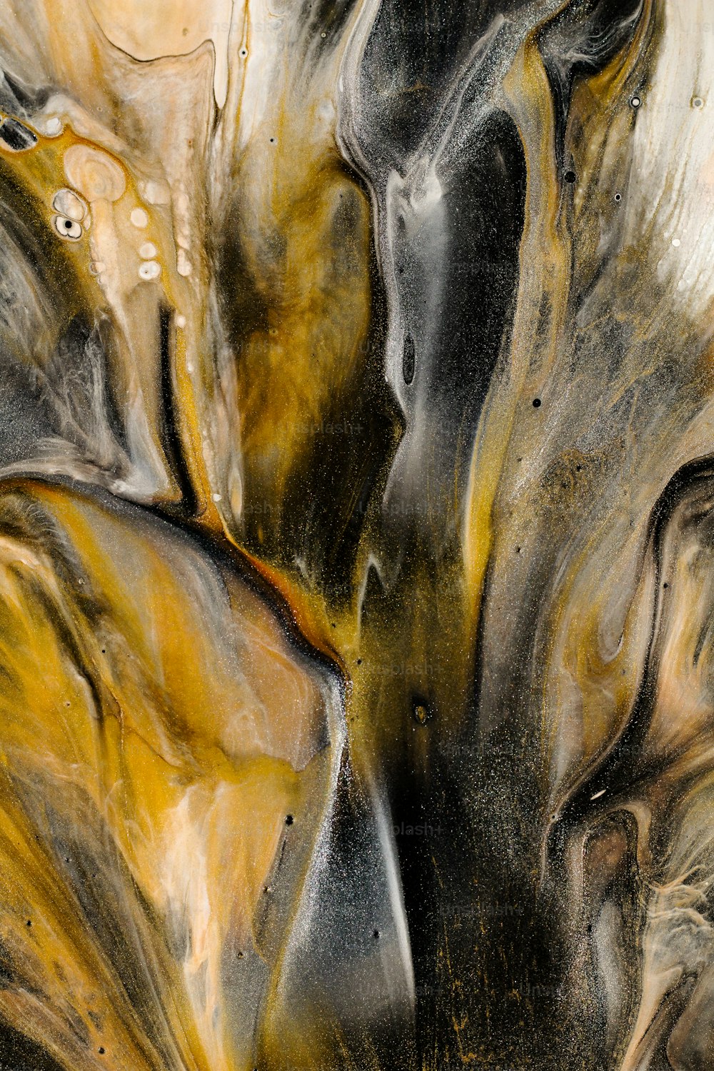 a close up of a black and yellow abstract painting