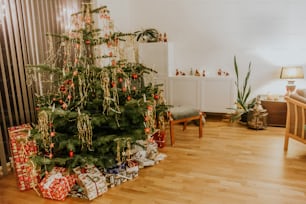 a christmas tree with presents under it in a living room