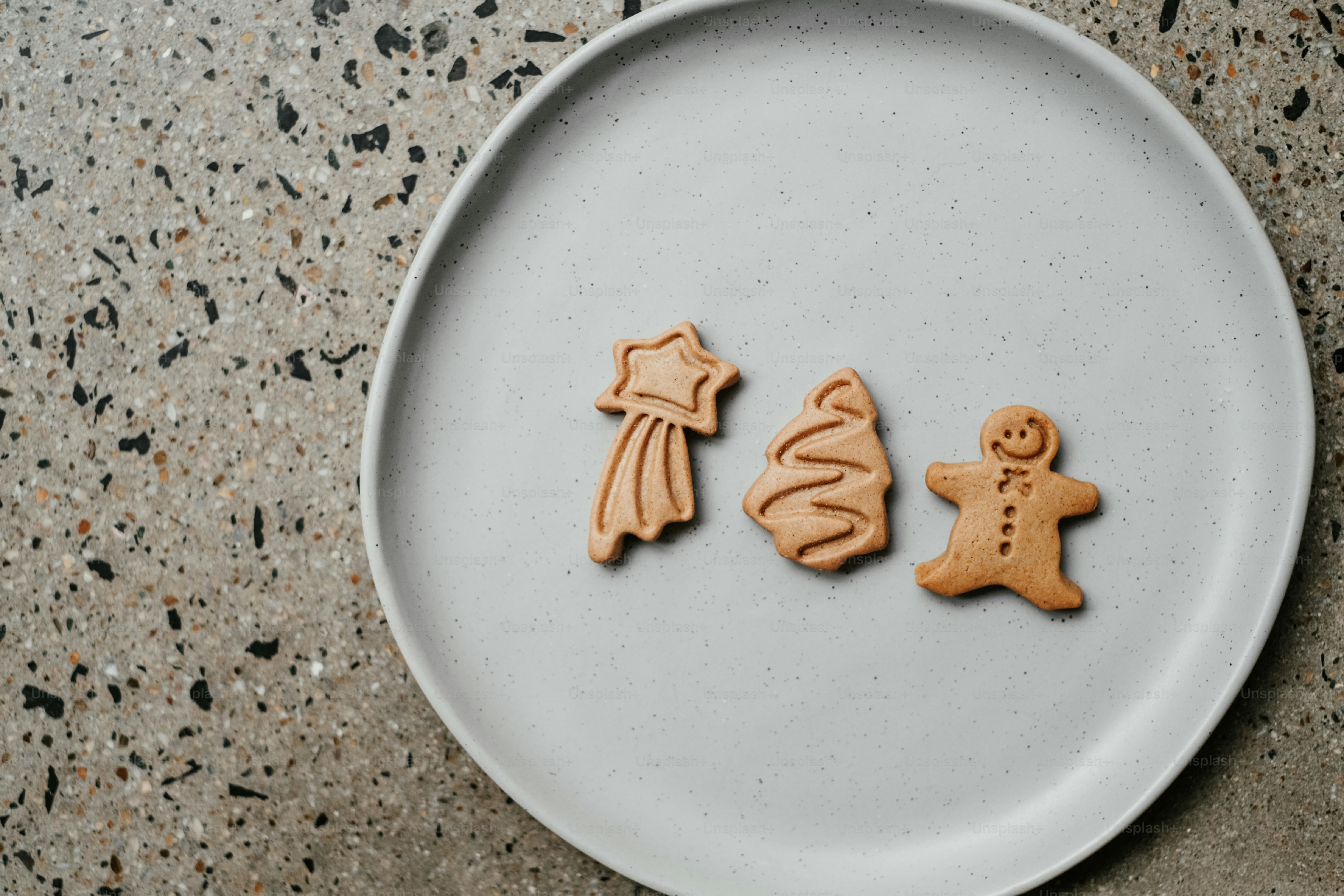 a white plate topped with two cookies shaped like a man and a woman