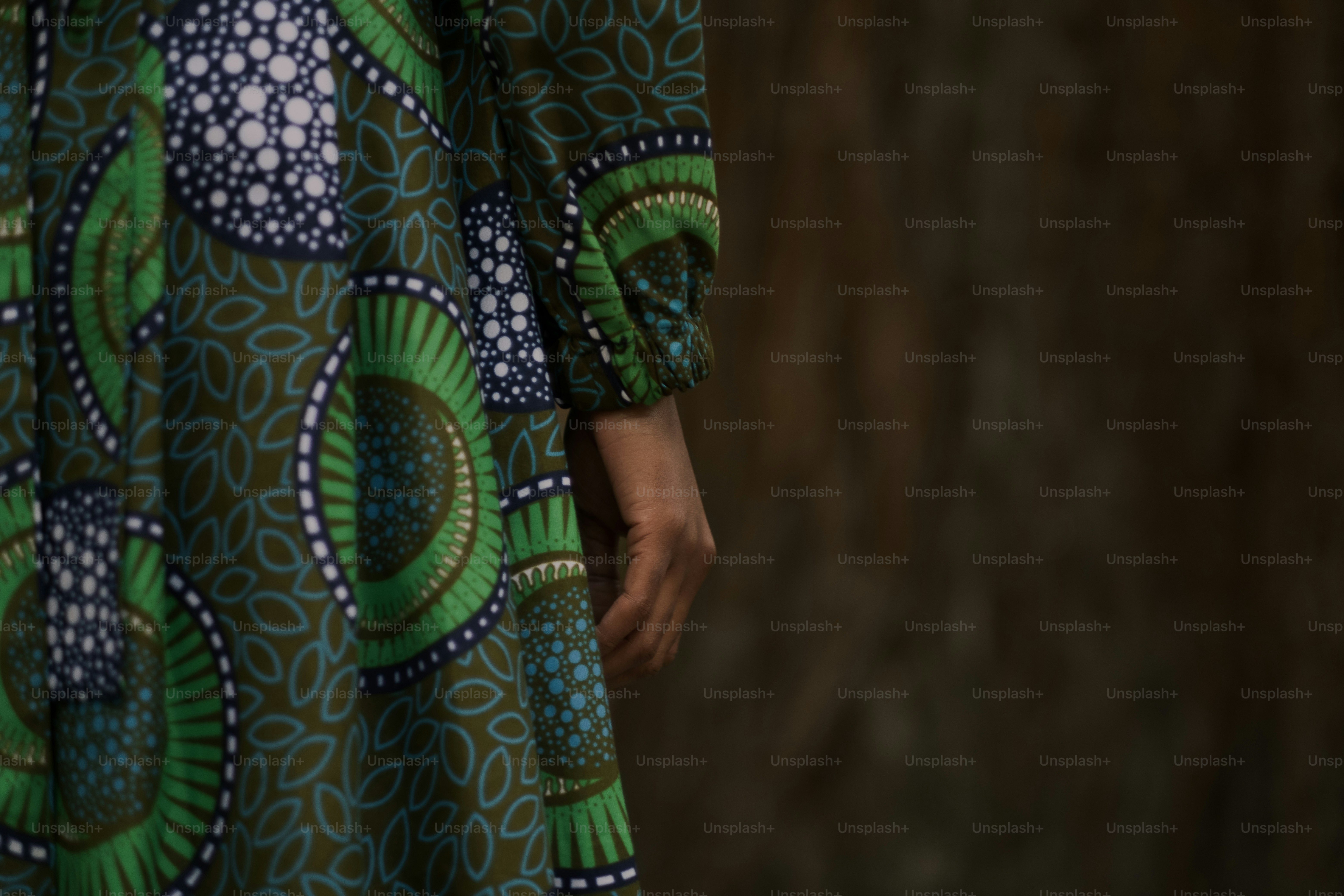 A woman in a green and blue dress with her hands on her hips photo ...