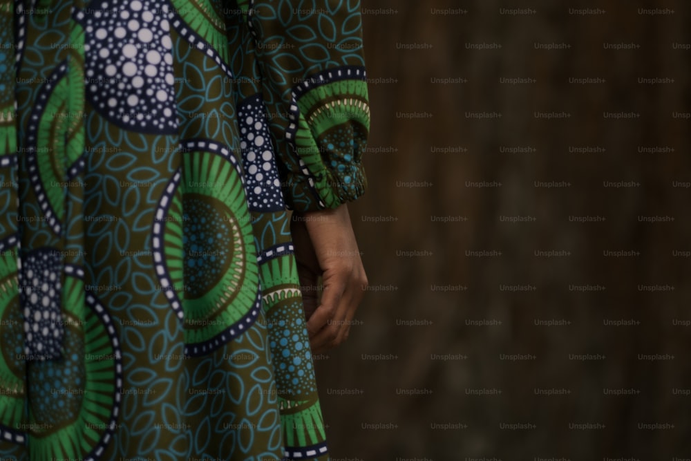 a close up of a person wearing a green and blue dress