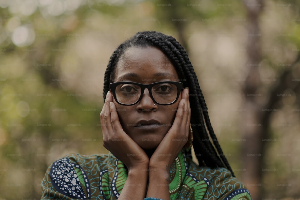 a woman with glasses is posing for a picture