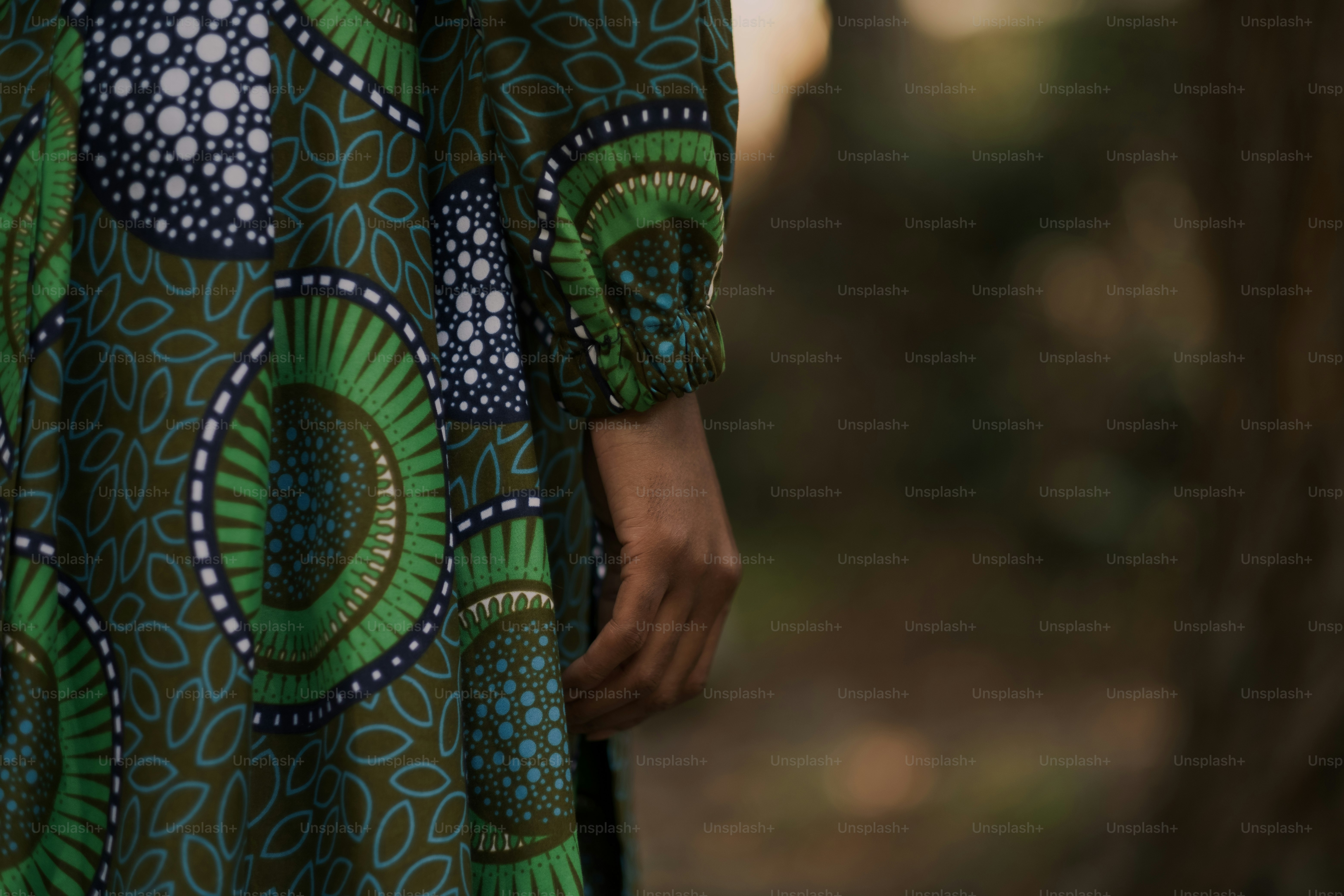 Eine Nahaufnahme einer Person, die ein grün-blaues Kleid trägt