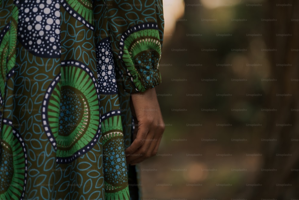 a close up of a person wearing a green and blue dress