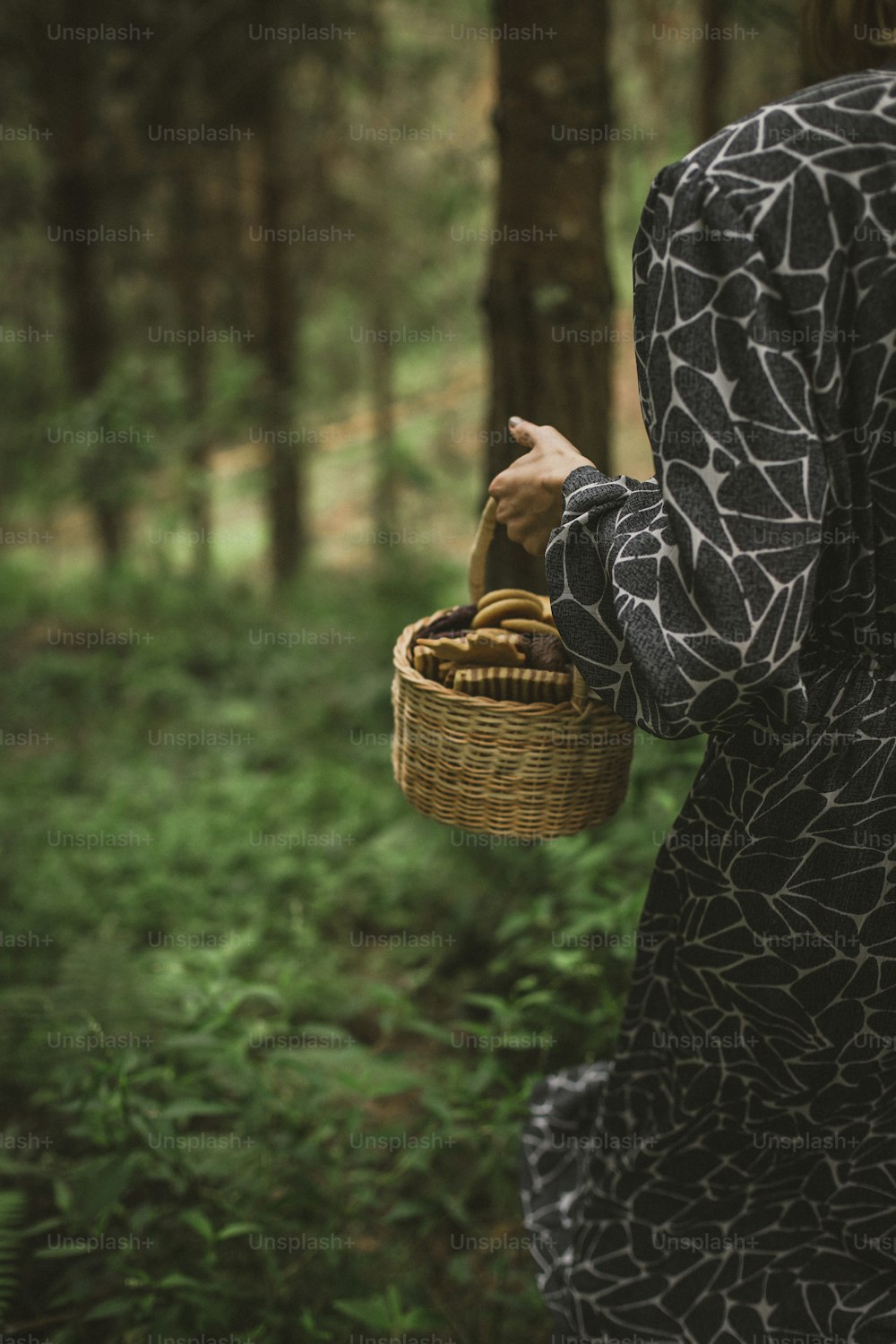 a woman holding a basket in a forest