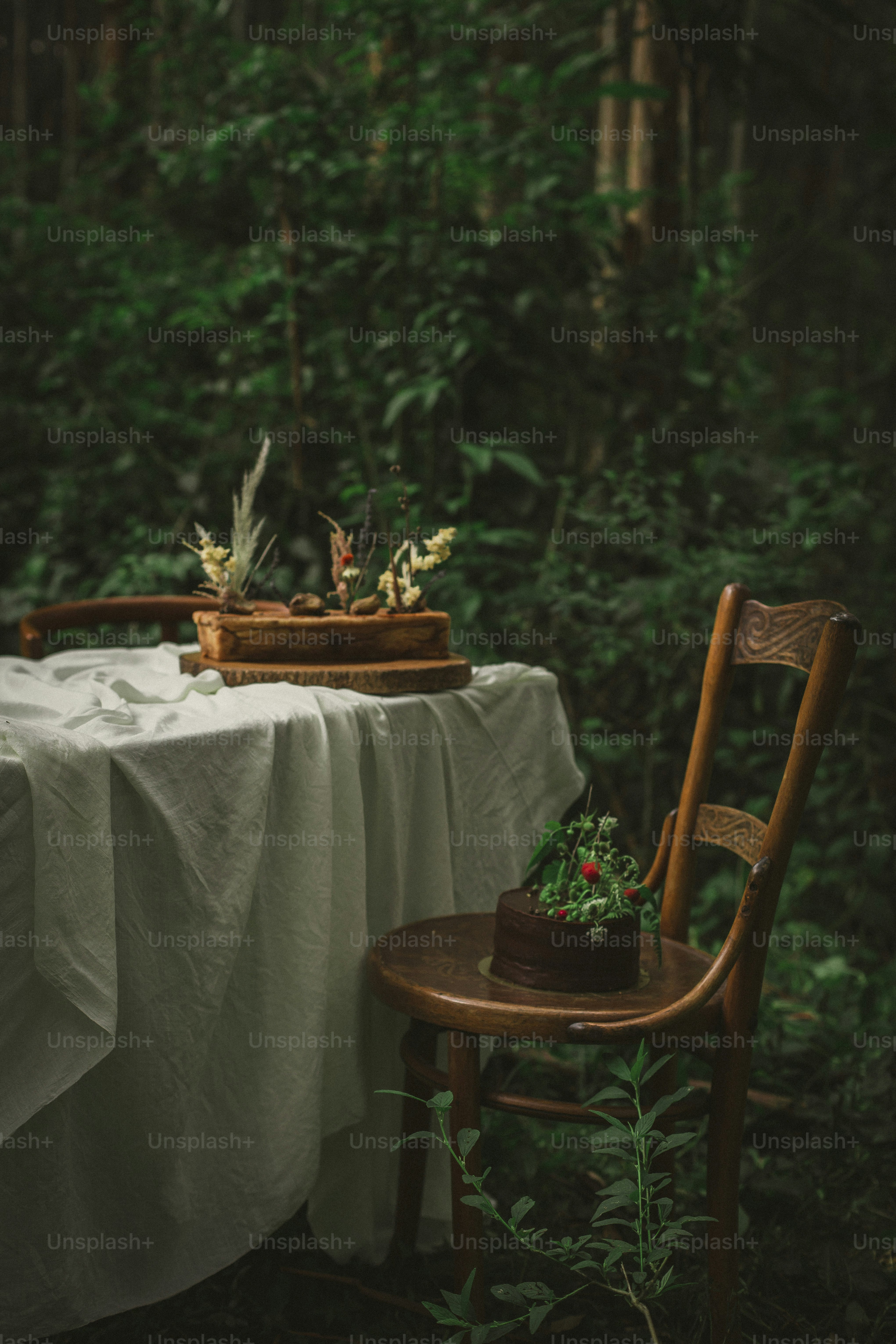 a table with a white table cloth and a wooden chair
