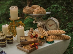 a table topped with lots of food and candles