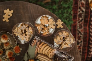 a wooden table topped with cookies and cookies