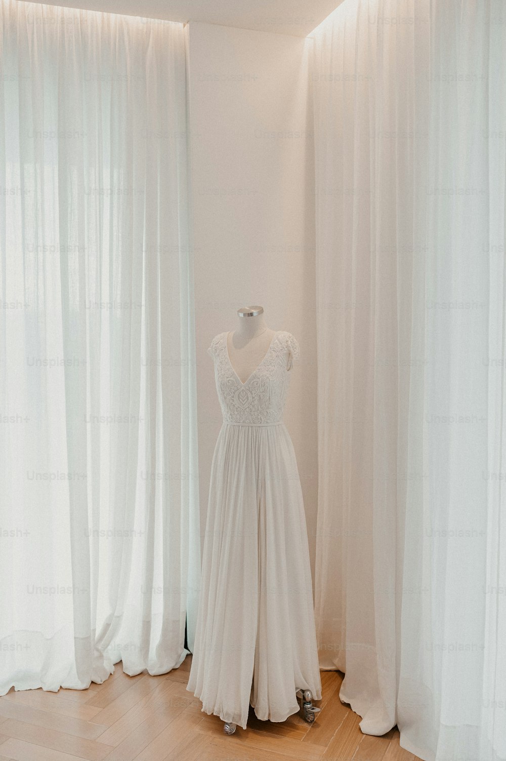 a dress on a mannequin in front of a window