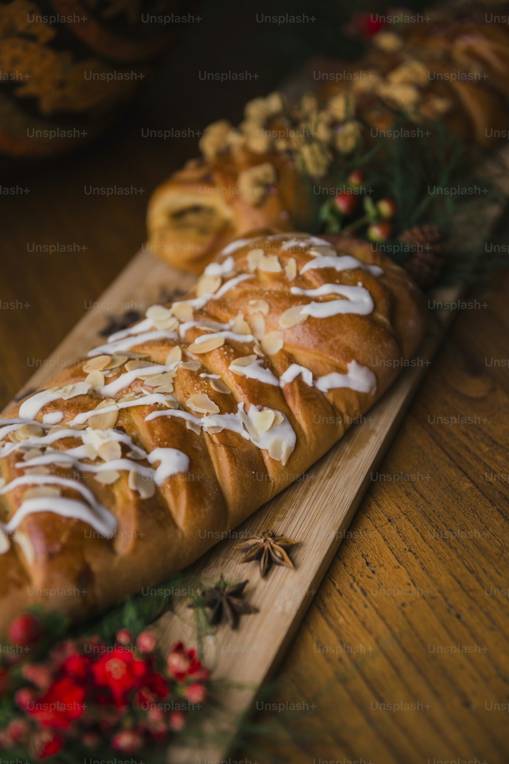 a long loaf of bread with white icing on a cutting board