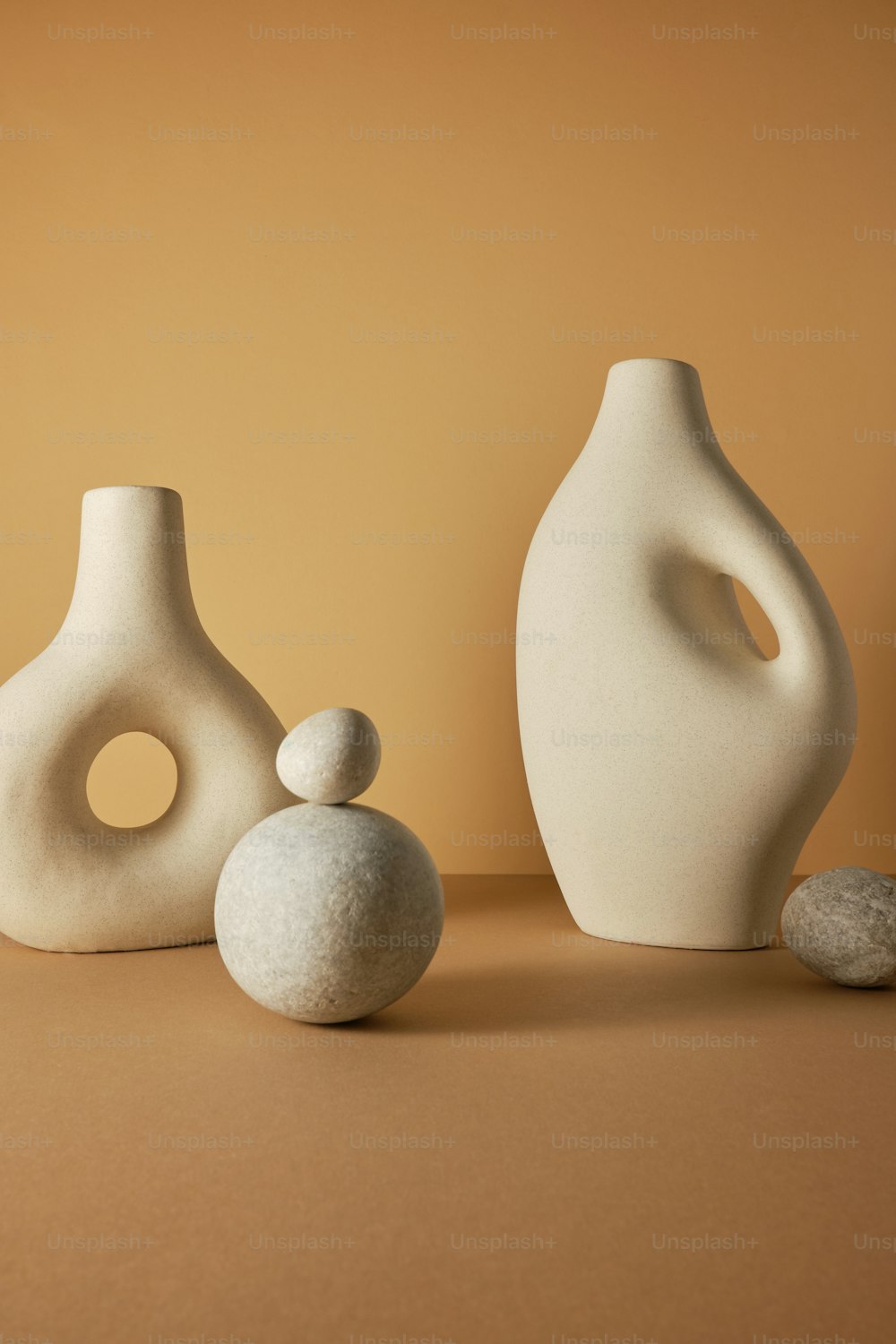 a couple of white vases sitting on top of a table