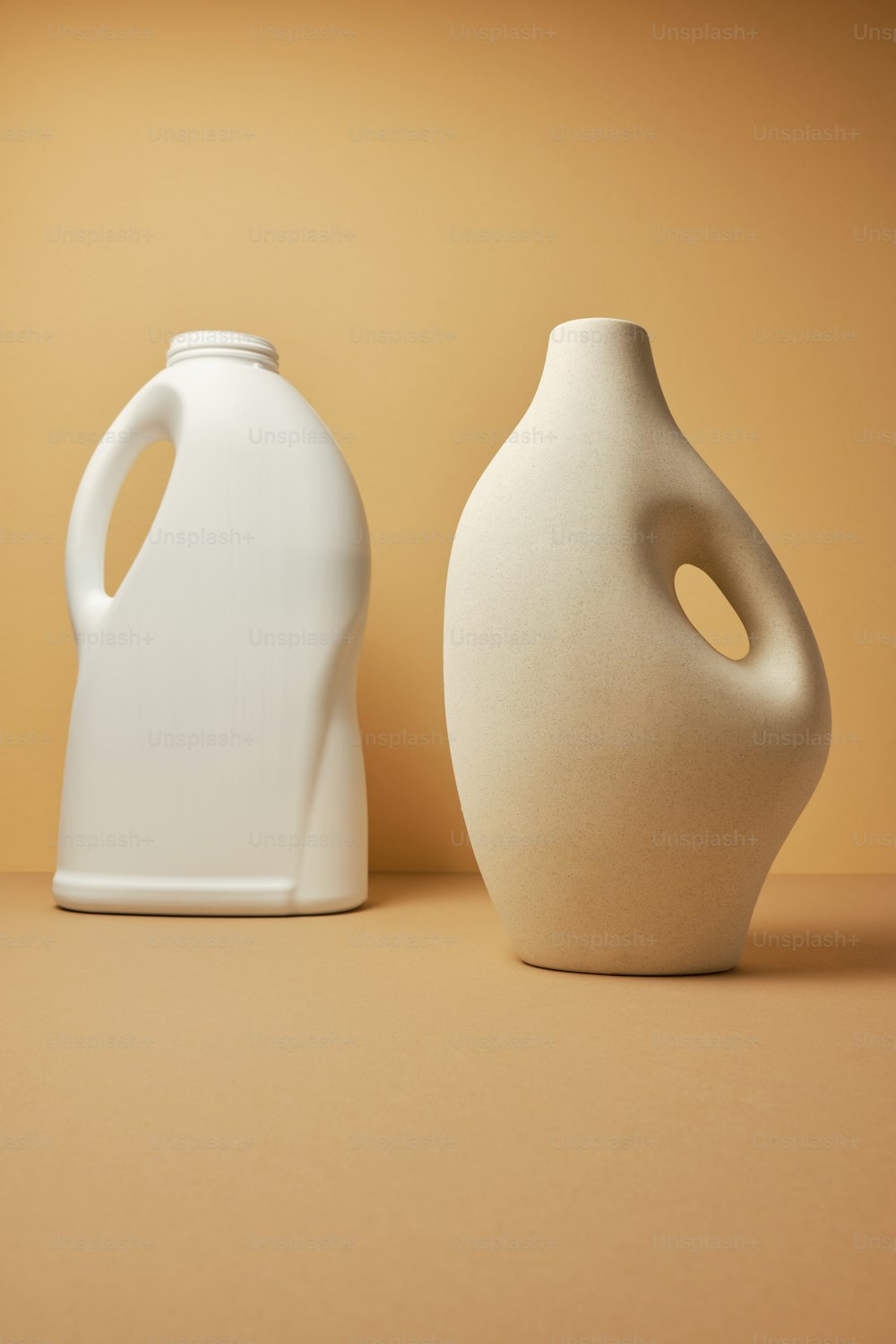 um par de vasos brancos sentados em cima de uma mesa
