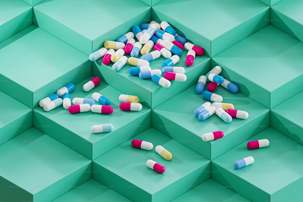 a bunch of pills sitting on top of a green box