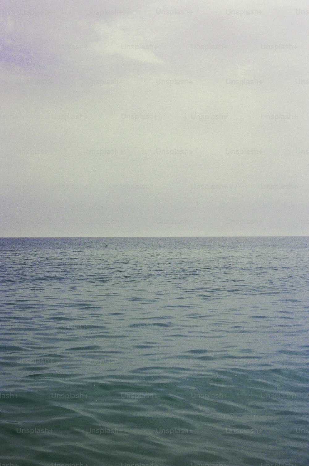 a large body of water sitting under a cloudy sky