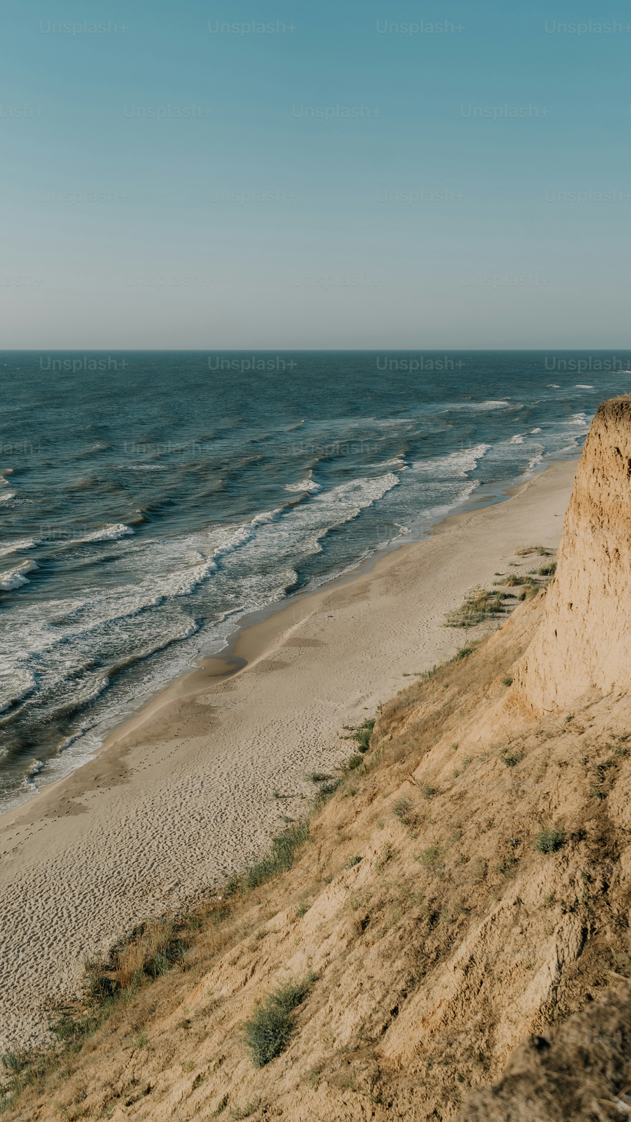 a view of the ocean from the top of a hill