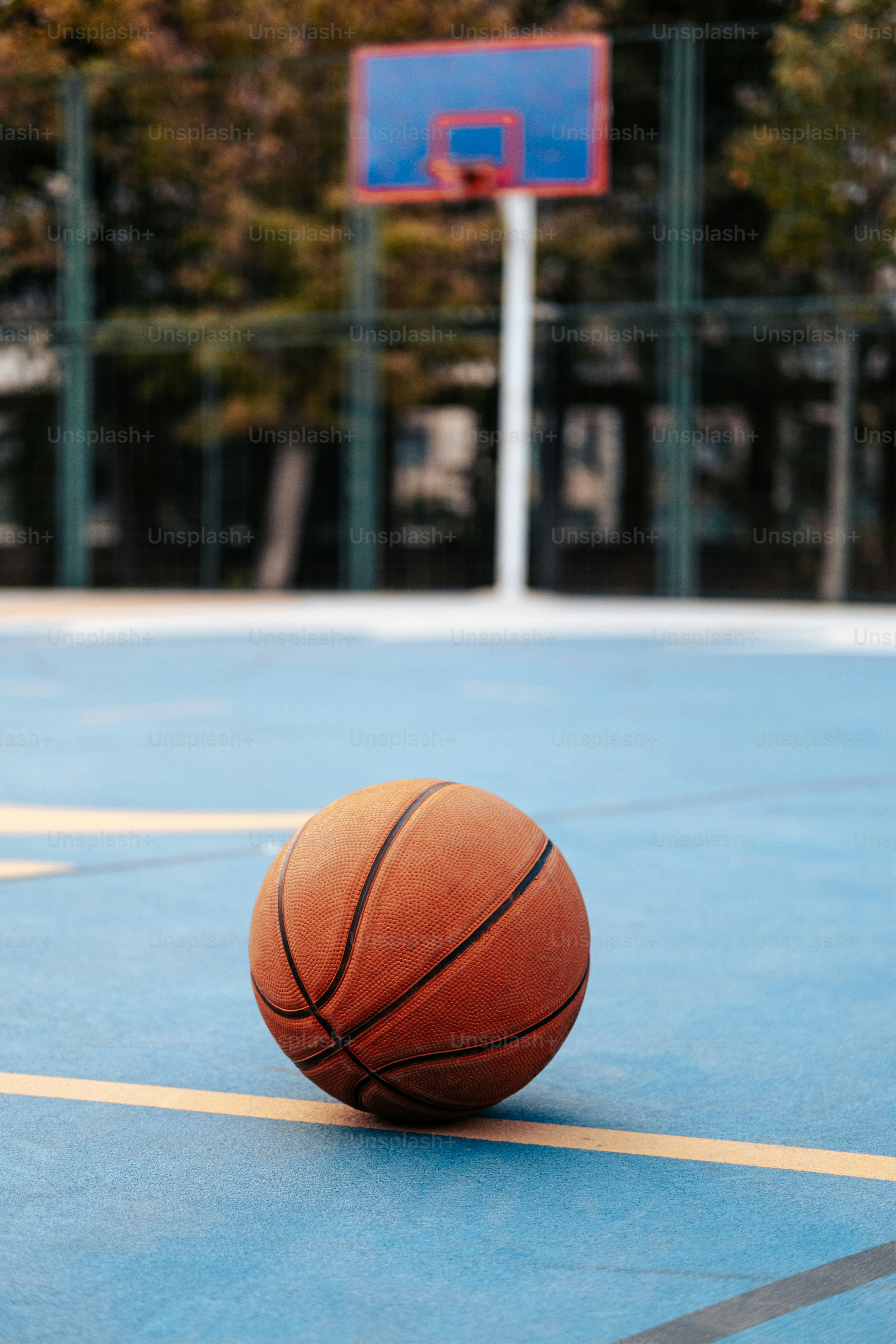 a basketball is sitting on a basketball court