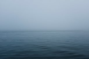 a large body of water with a boat in the distance